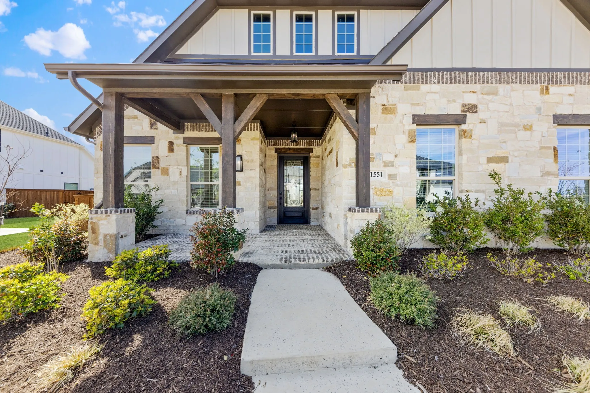 This charming covered front porch is the perfect place to welcome family and friends into your forever home!