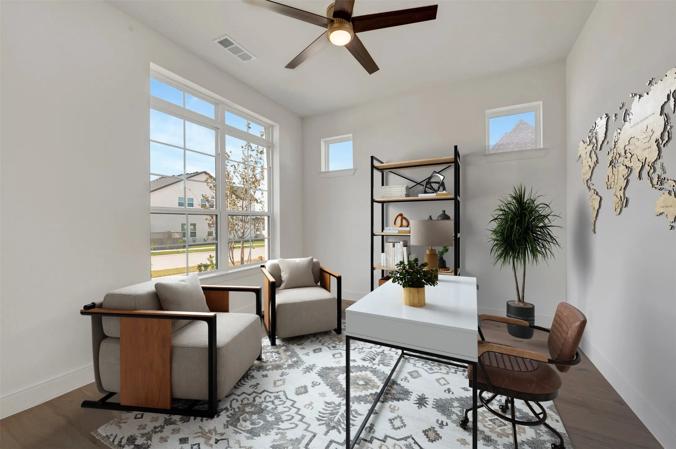 Light-filled room featuring large picture windows, wood-finish flooring, a ceiling fan, and white walls