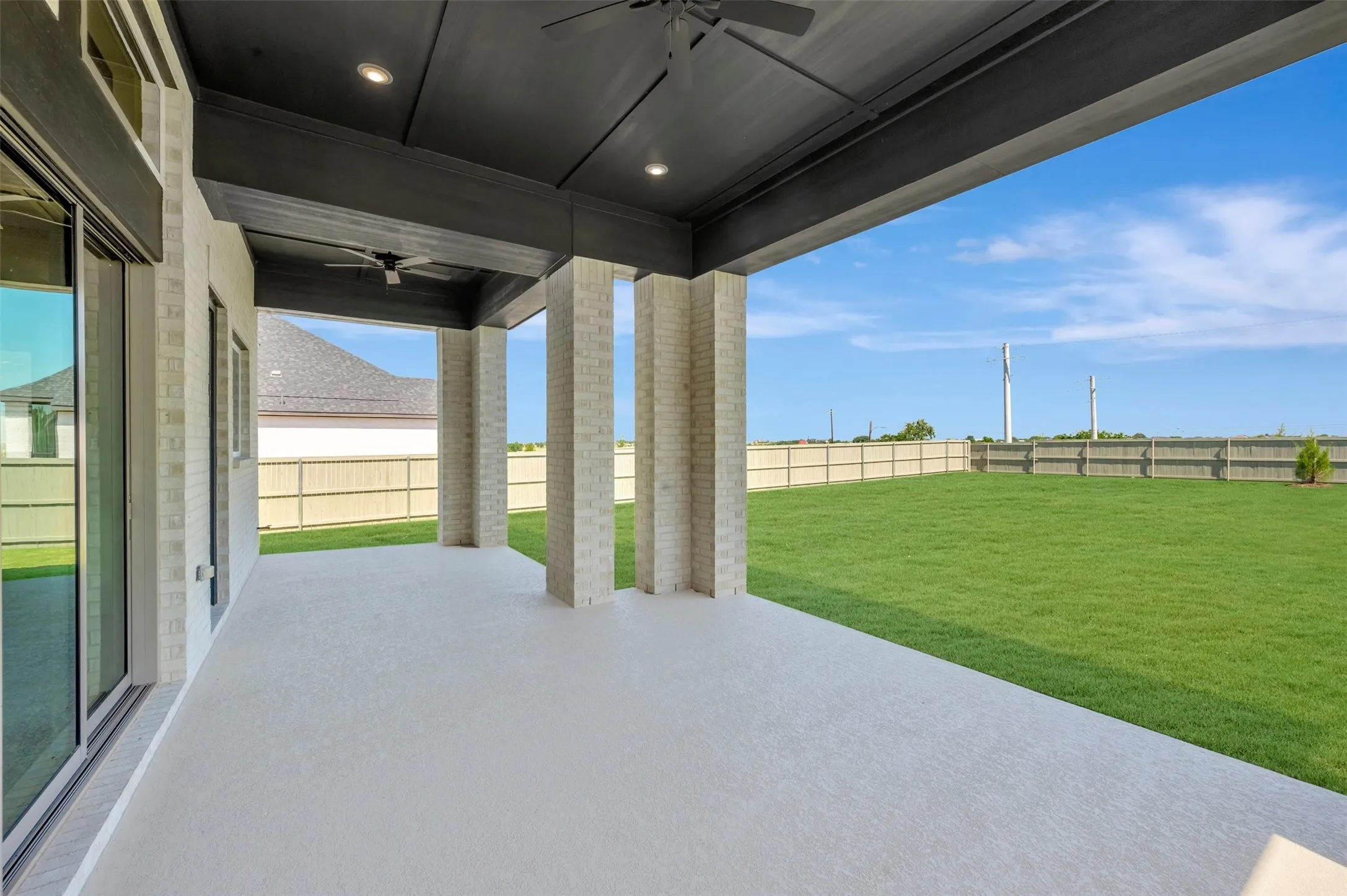 Expansive covered patio featuring a concrete surface and recessed lighting