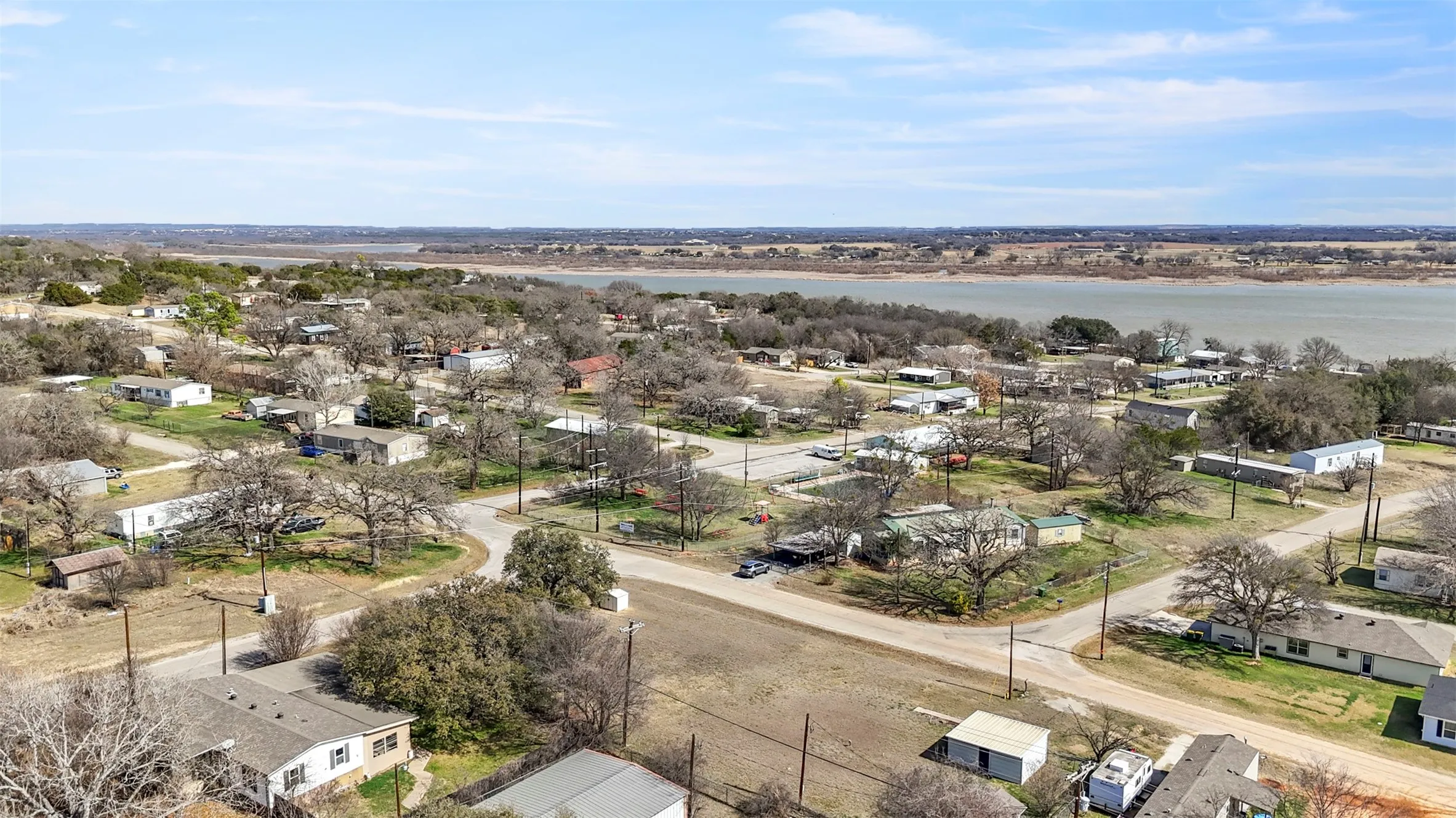 Aerial perspective of suburban area featuring a large body of water