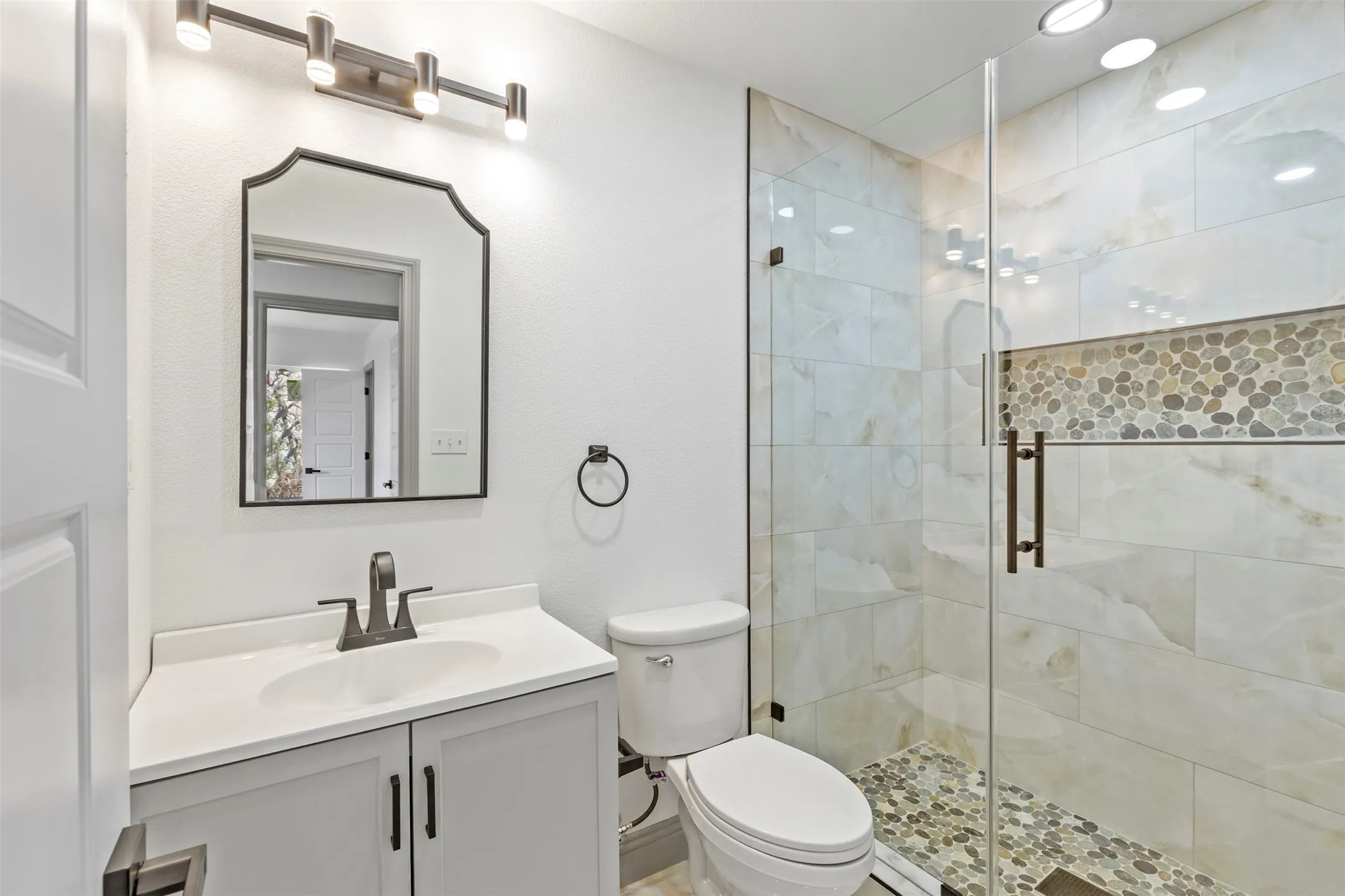 Bathroom with vanity and a stall shower