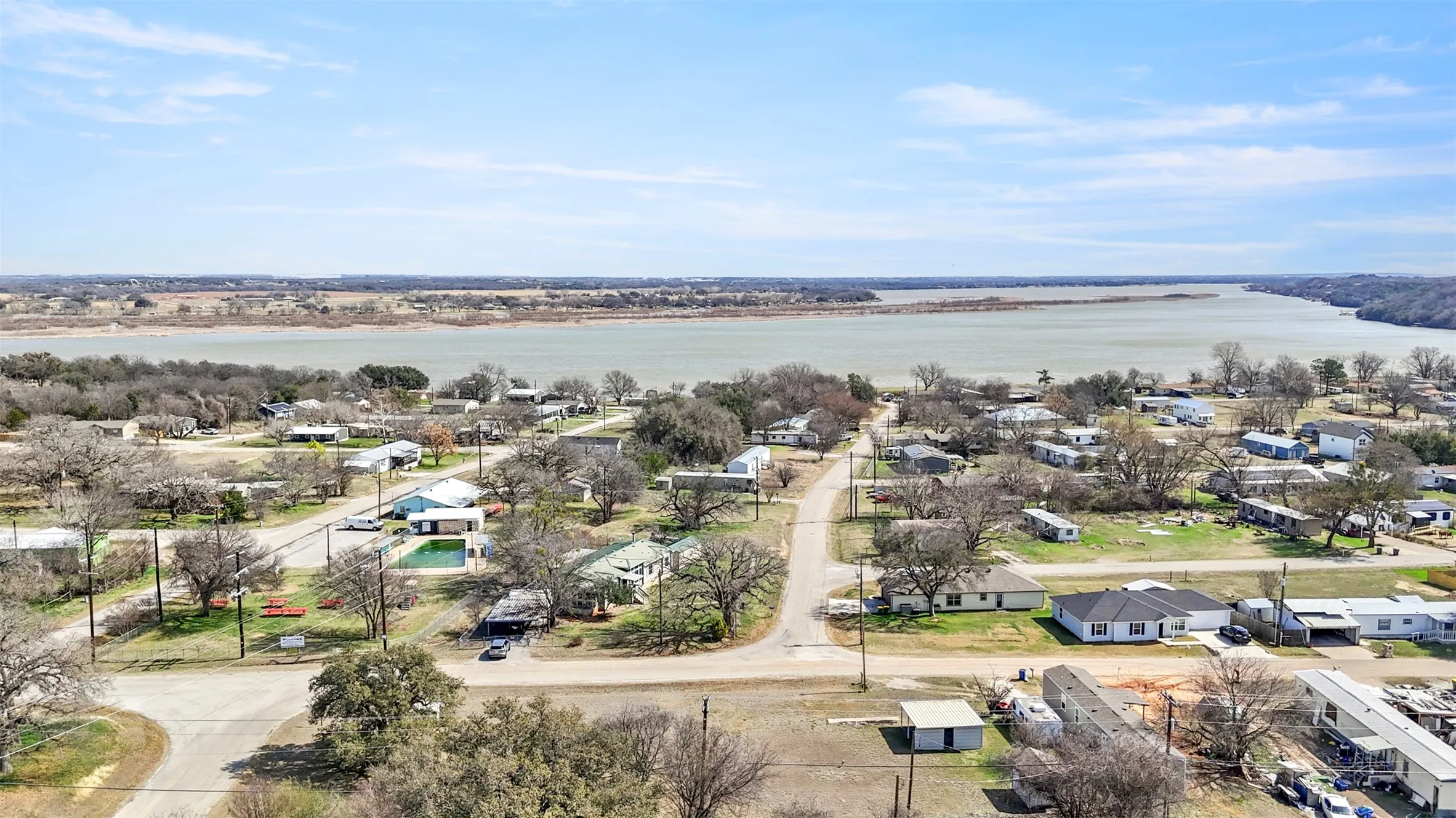 Aerial perspective of suburban area featuring a large body of water