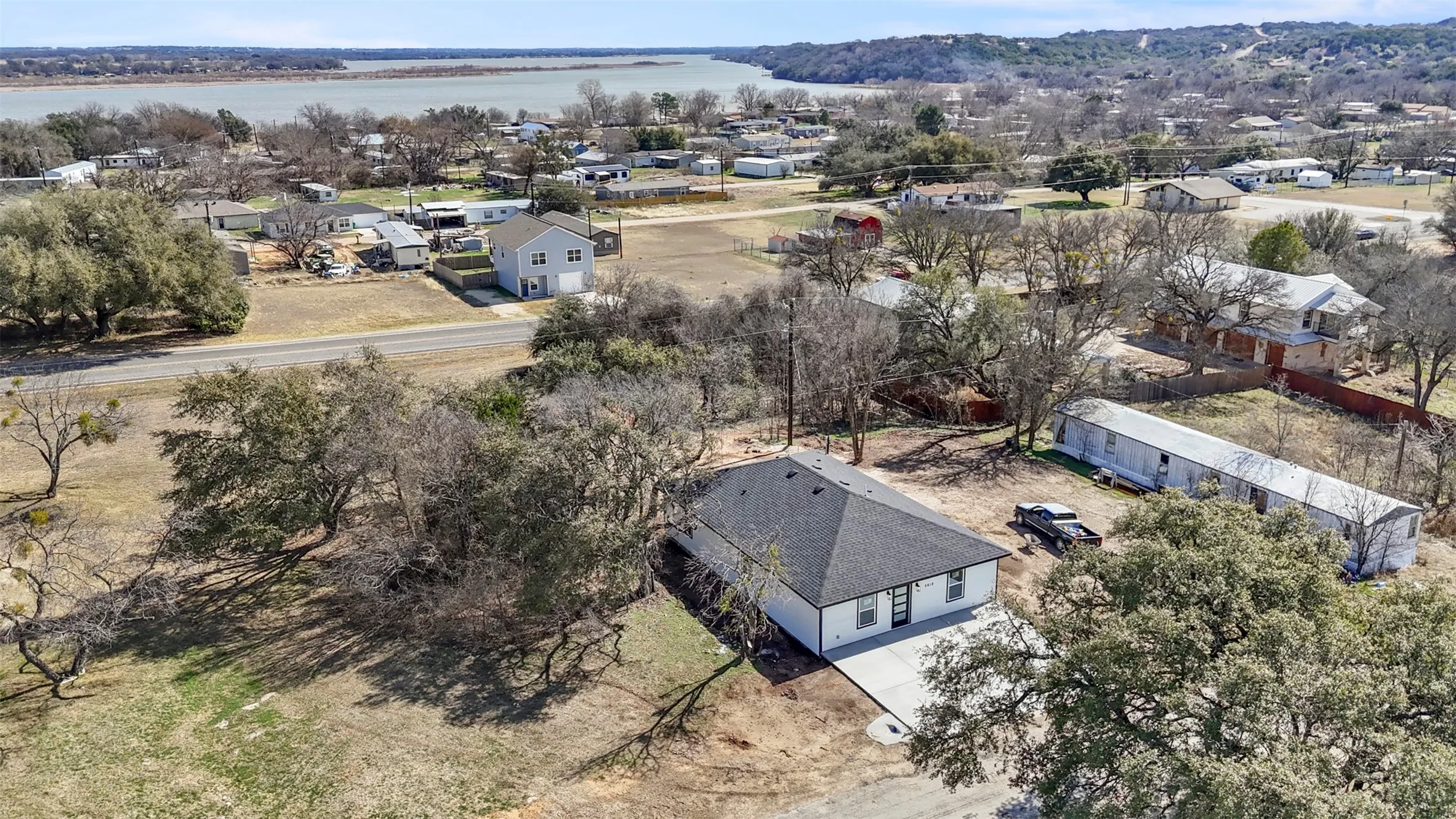 Aerial perspective of suburban area with a nearby body of water