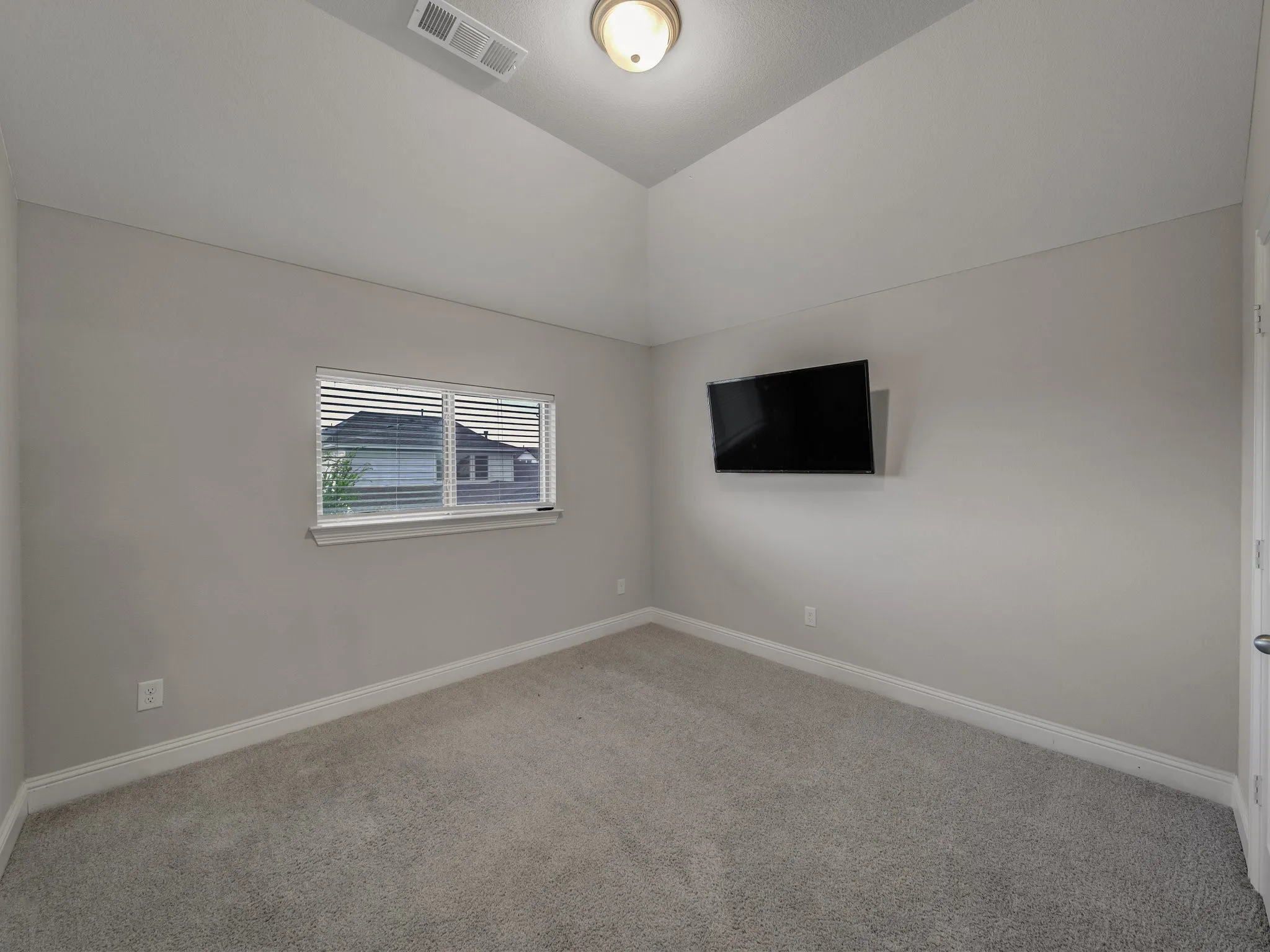 Carpeted empty room with baseboards