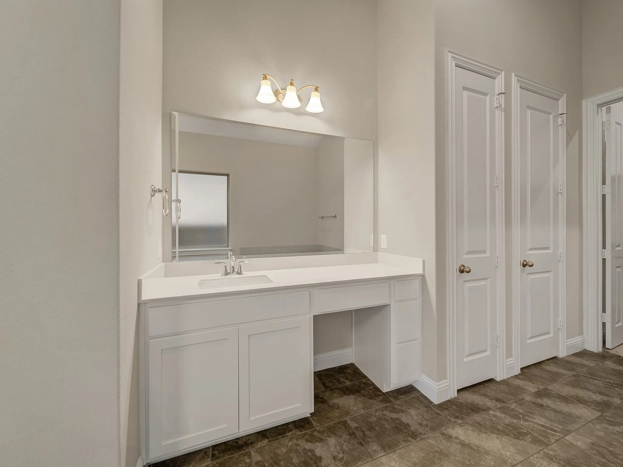 Bathroom with vanity and baseboards