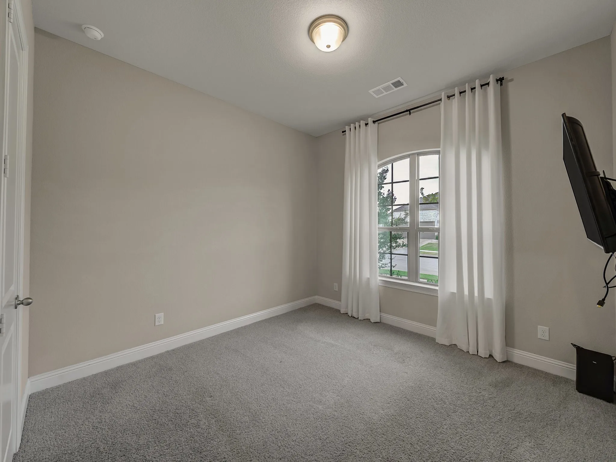 Unfurnished room featuring carpet and baseboards
