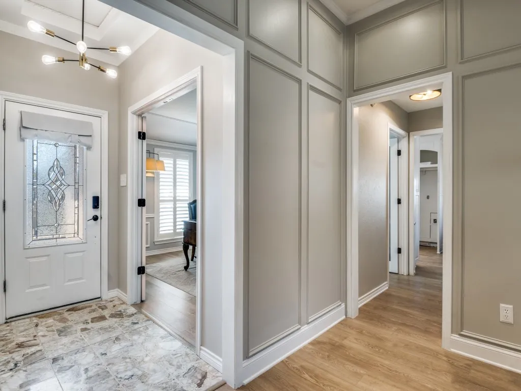 Entryway opens to living and to flex space that could be a private office, as seen here, or elegant formal dining.