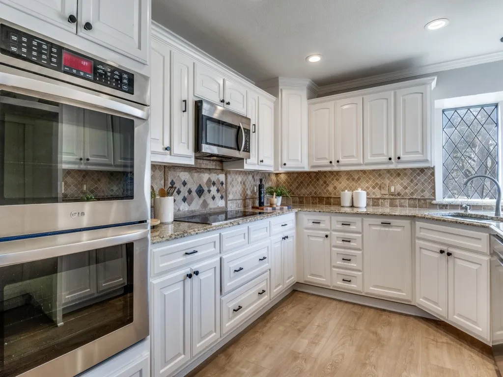 Kitchen is light and bright with plenty of cabinetry.