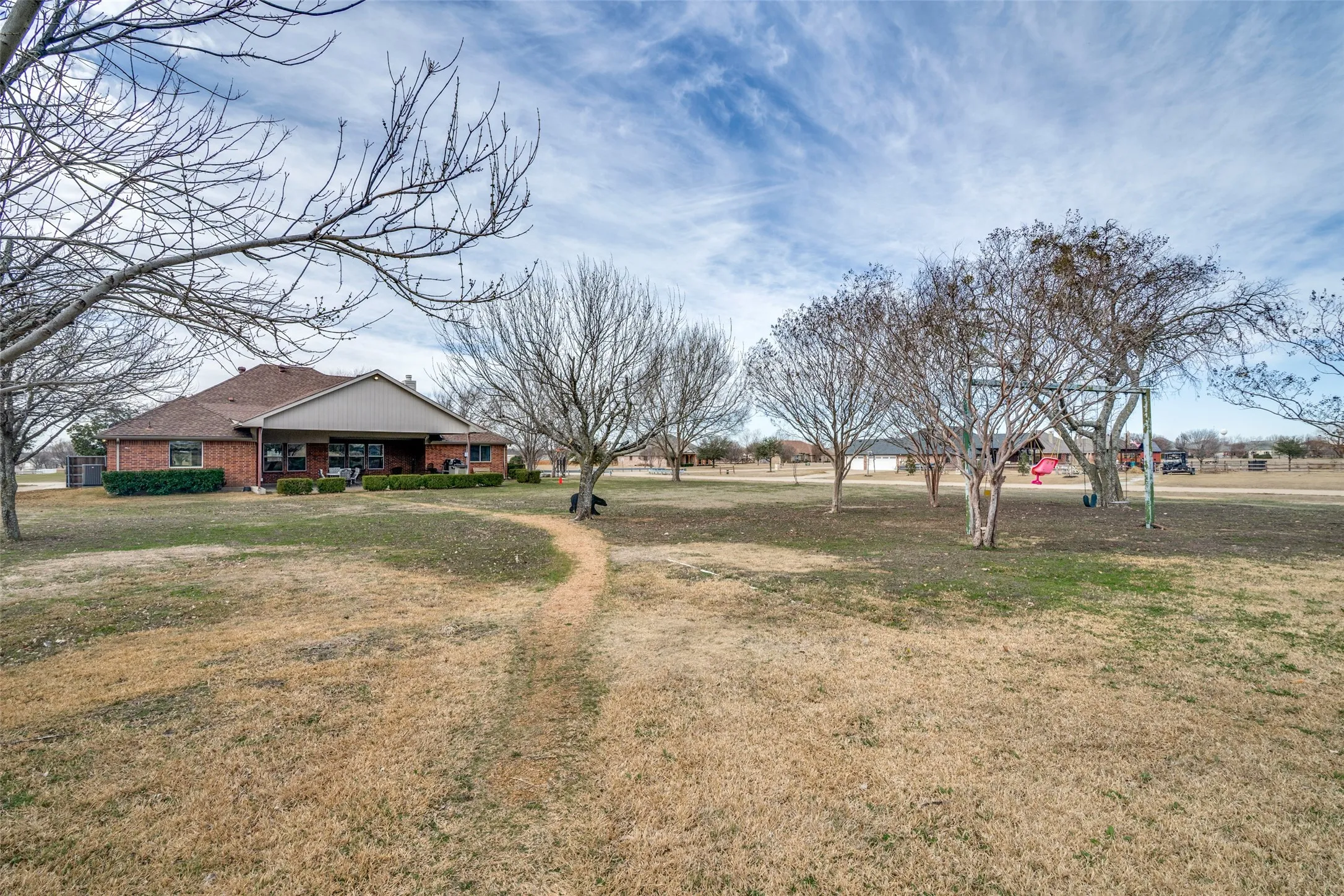 View of grassy yard with covered porch