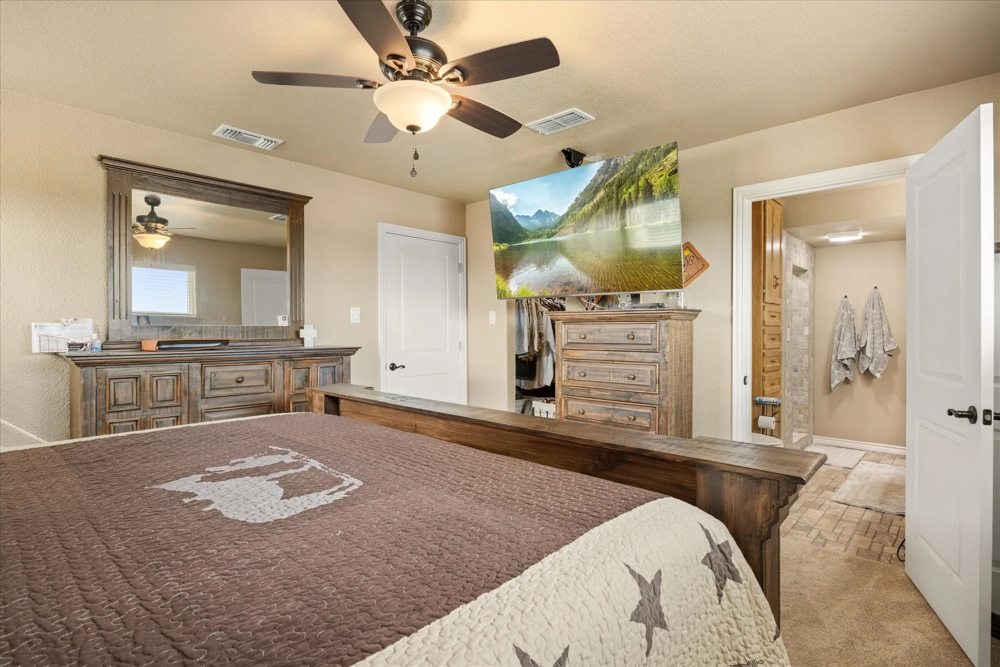 Carpeted bedroom with ceiling fan