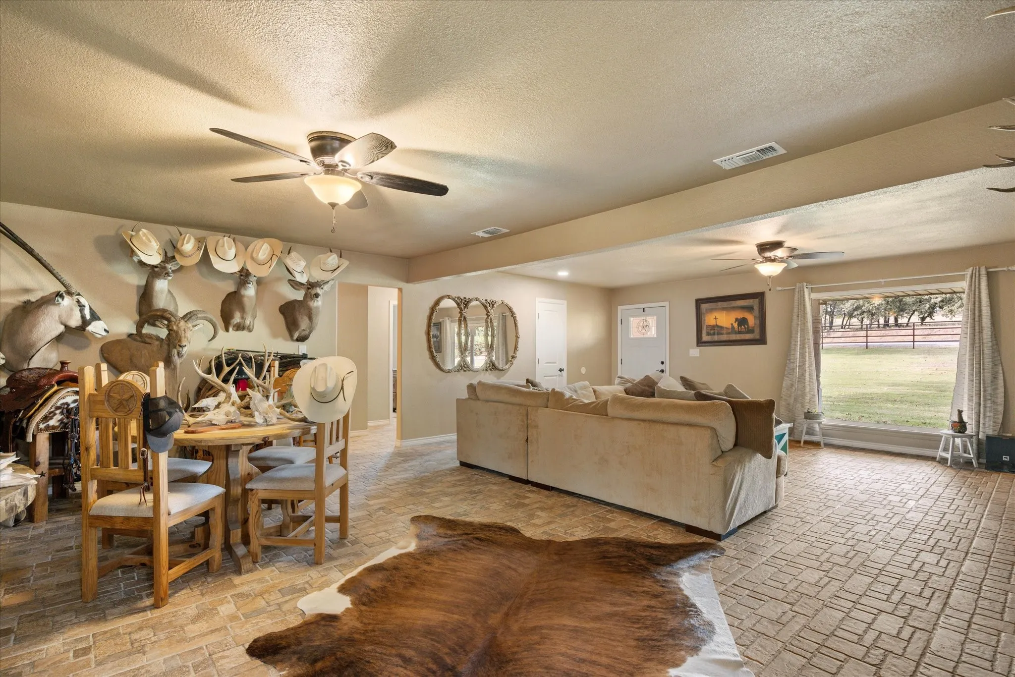 Living room with a textured ceiling and ceiling fan