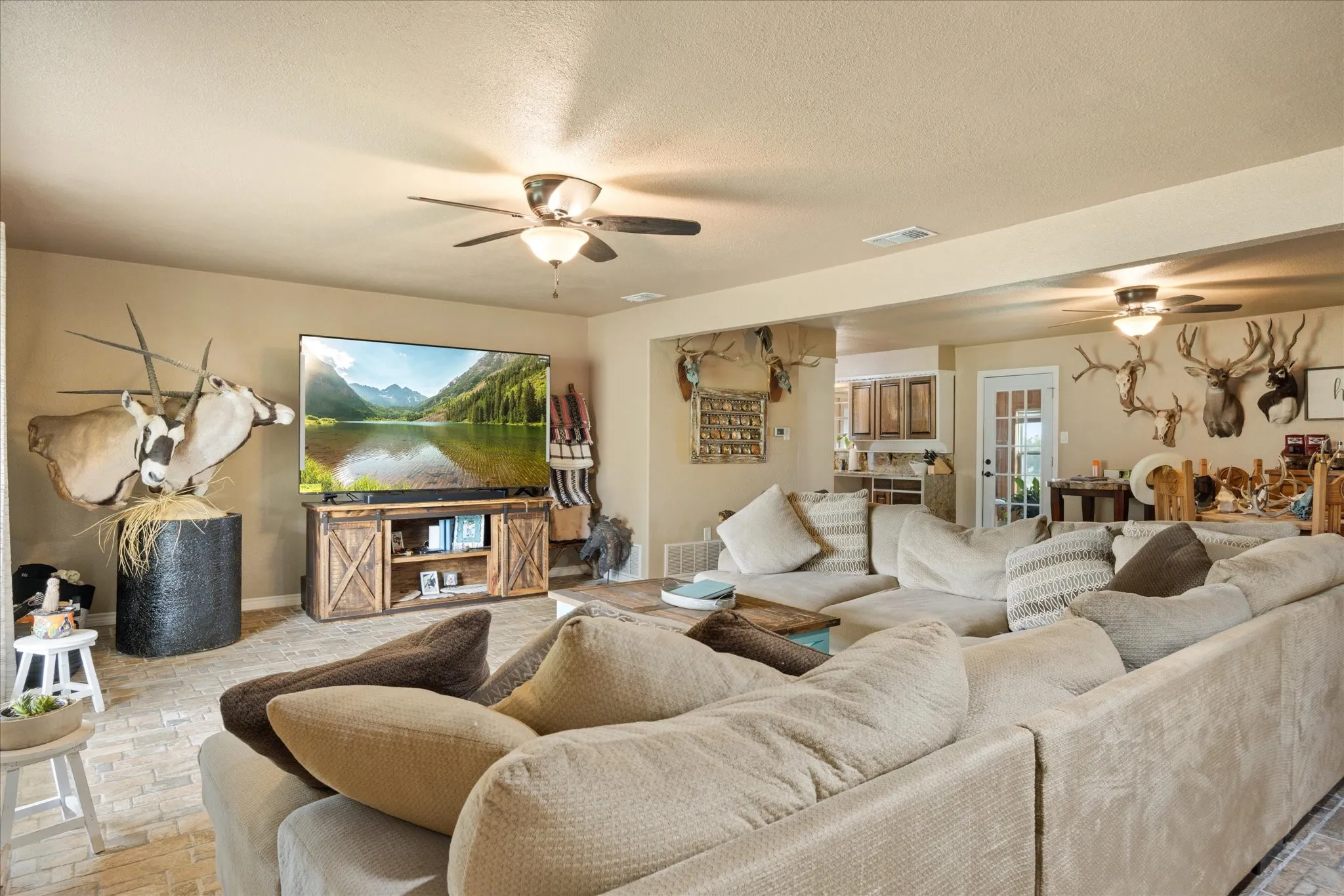 Living room featuring ceiling fan and a textured ceiling