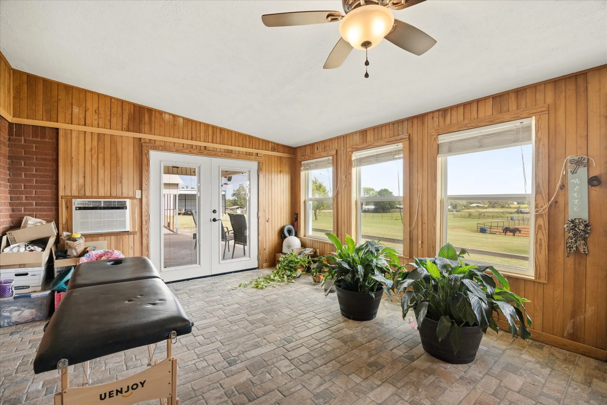 Sunroom / solarium featuring french doors, vaulted ceiling, cooling unit, and ceiling fan