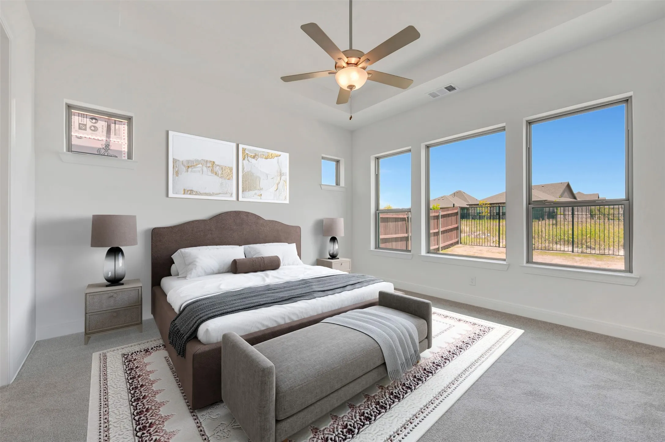 Spacious room featuring multiple windows with ample light, a ceiling fan with integrated lighting, and neutral-toned carpeting