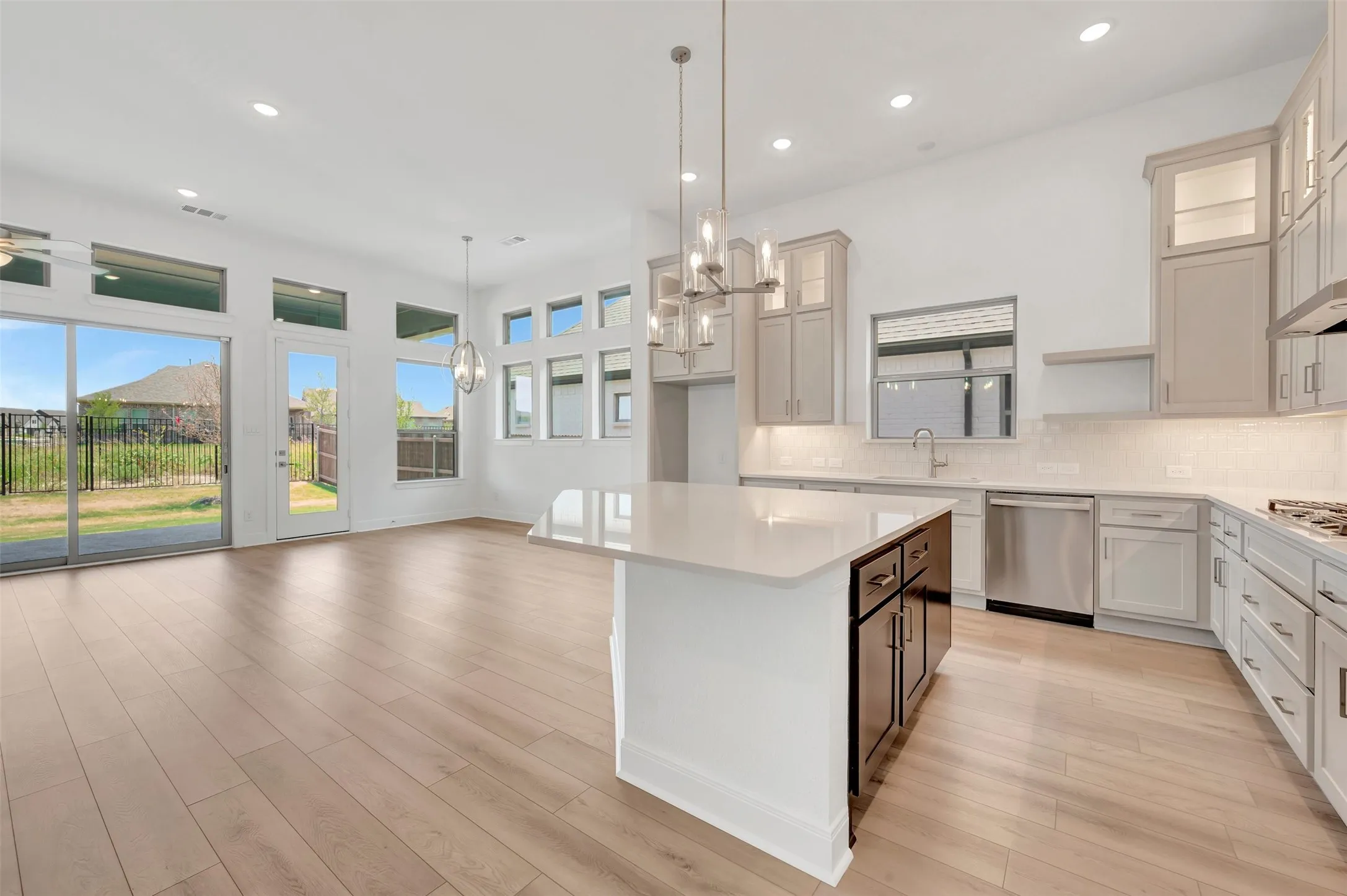 Open-concept living area with light wood-finish flooring