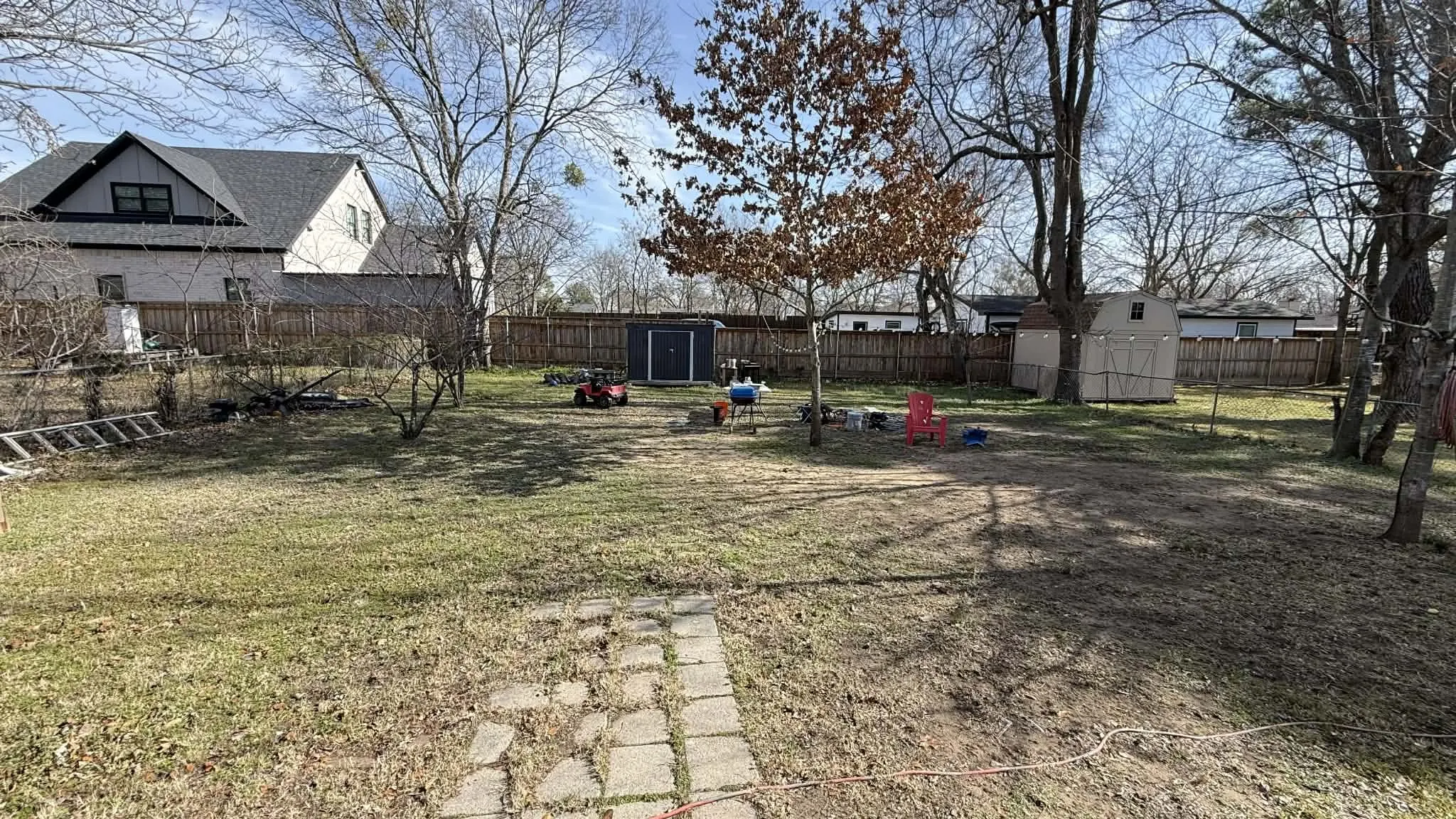 Fenced backyard with a storage shed