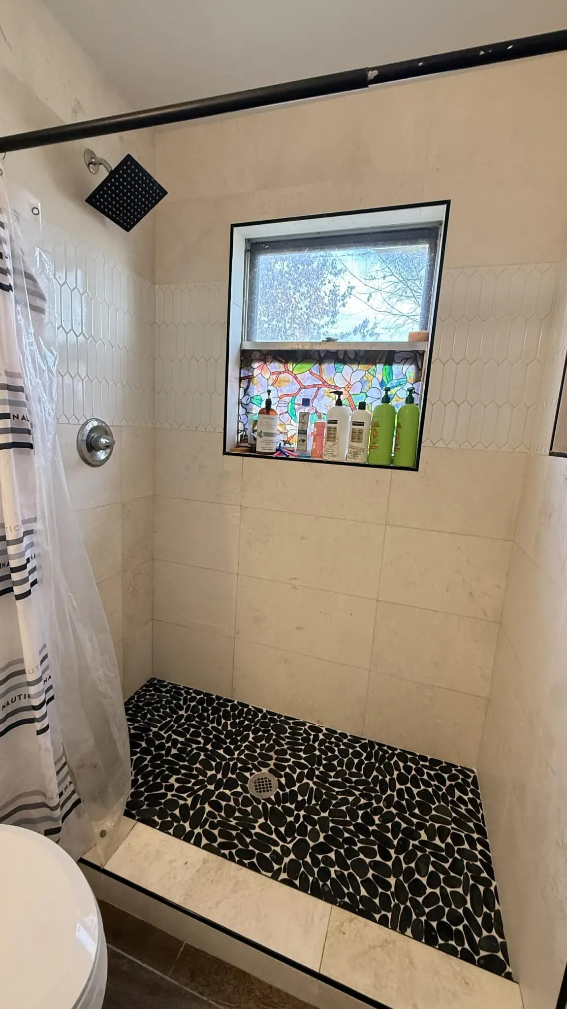 Full bath with toilet and a stall shower
