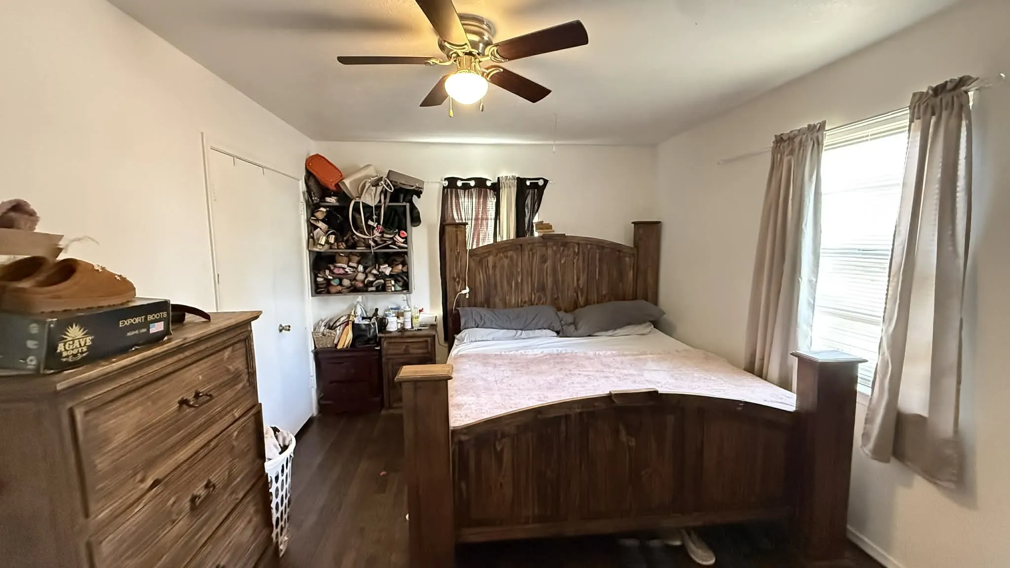 Bedroom with ceiling fan and dark wood finished floors