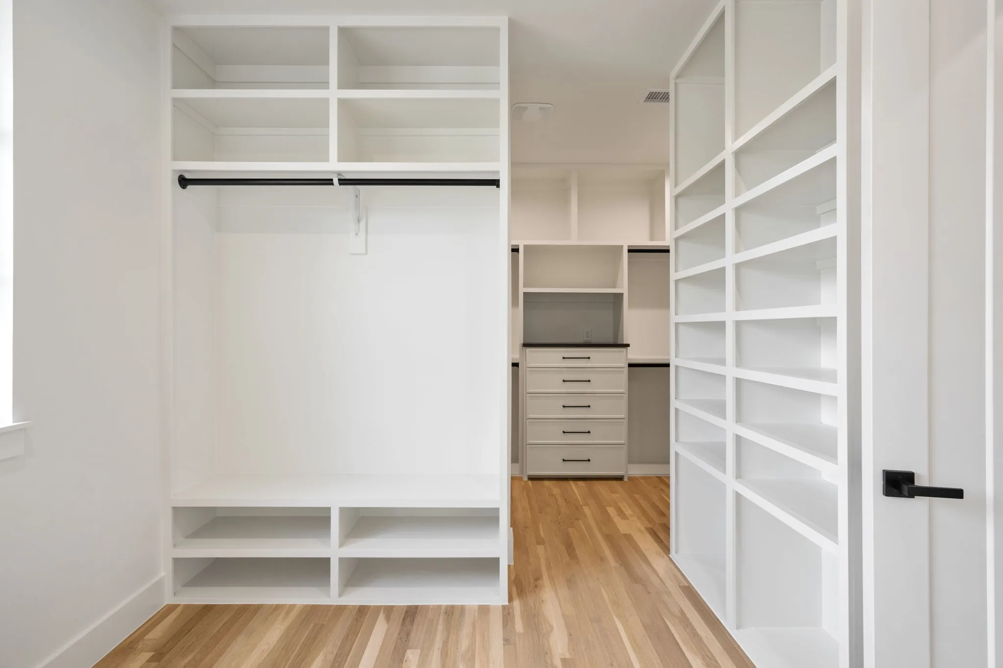 Walk in closet featuring light wood-style floors