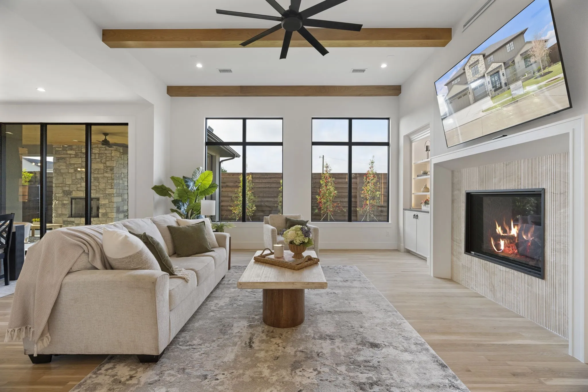 Living area featuring a tile fireplace, recessed lighting, light wood-type flooring, built in shelves, and a ceiling fan