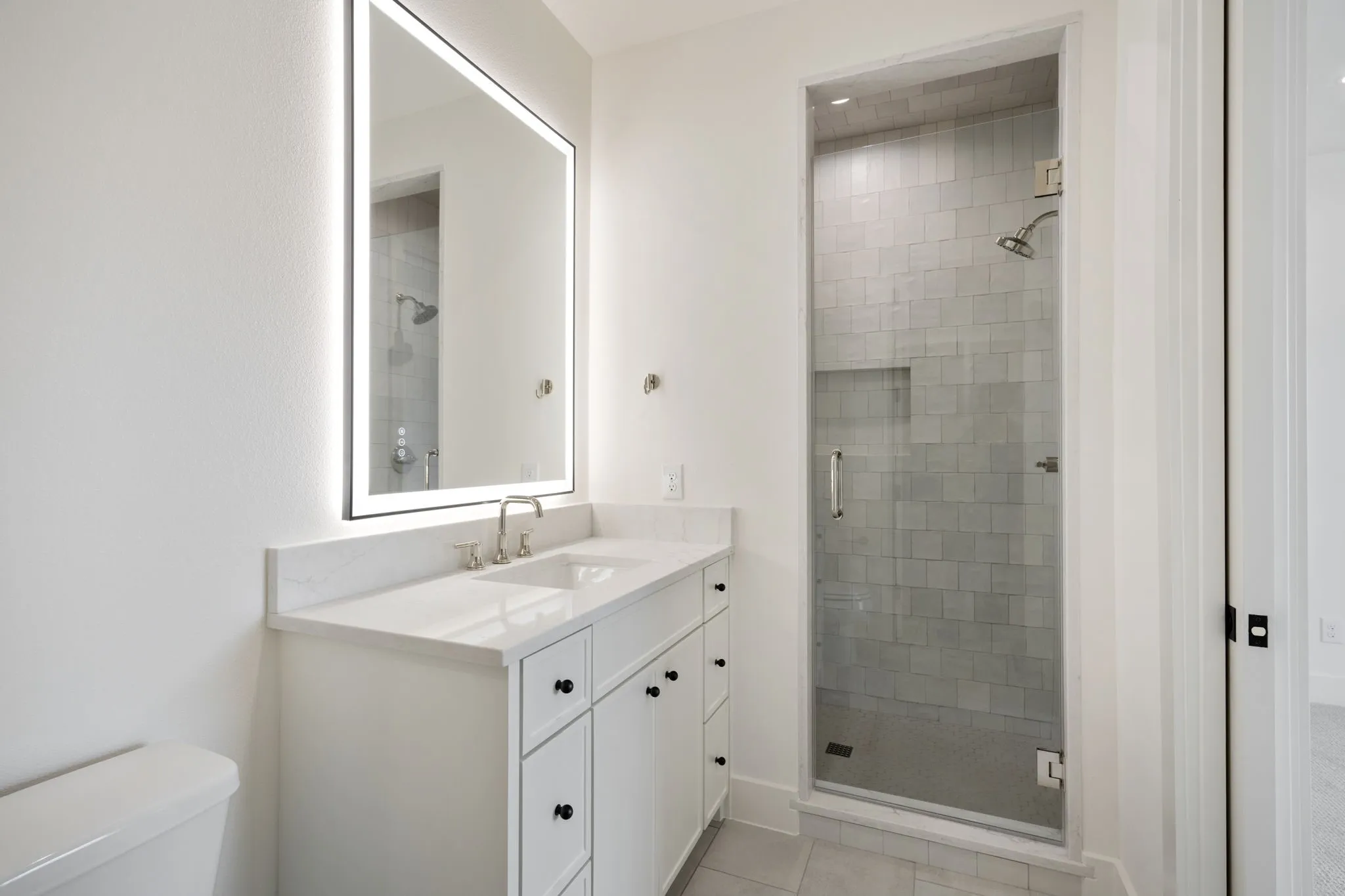 Bathroom with vanity, a stall shower, and light tile patterned flooring