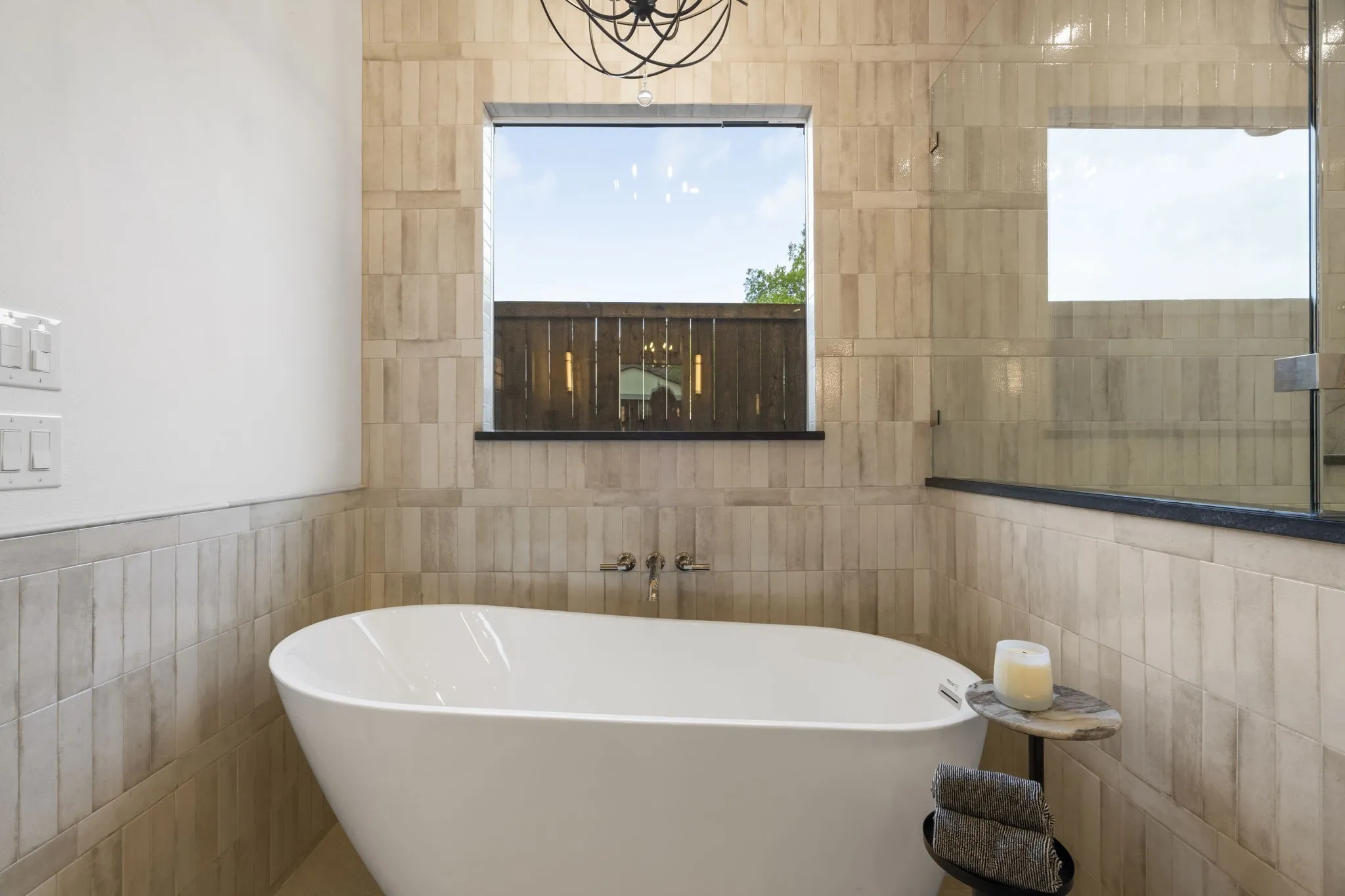 Full bath featuring tile walls and a freestanding tub