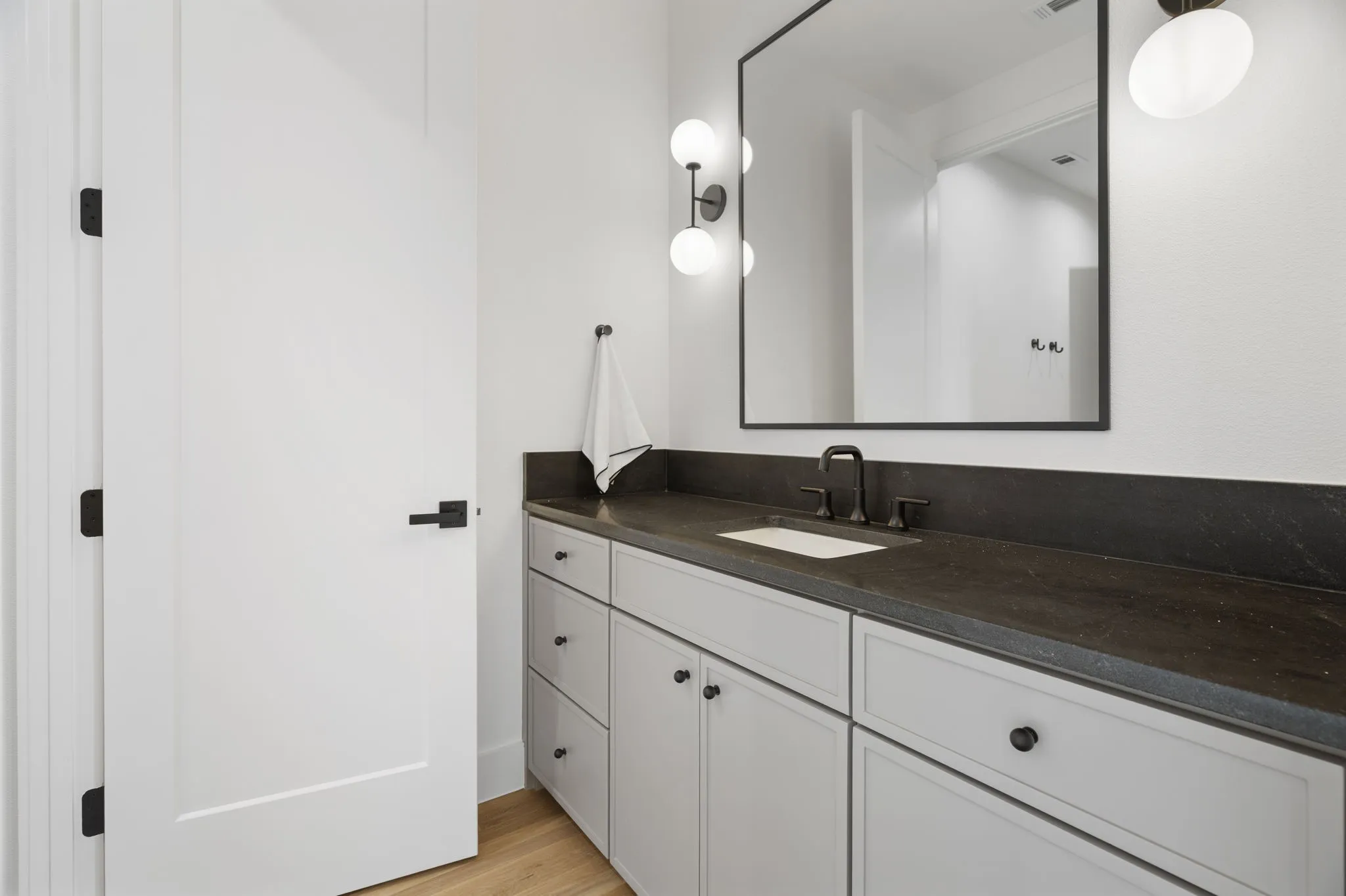 Bathroom with vanity and light wood finished floors