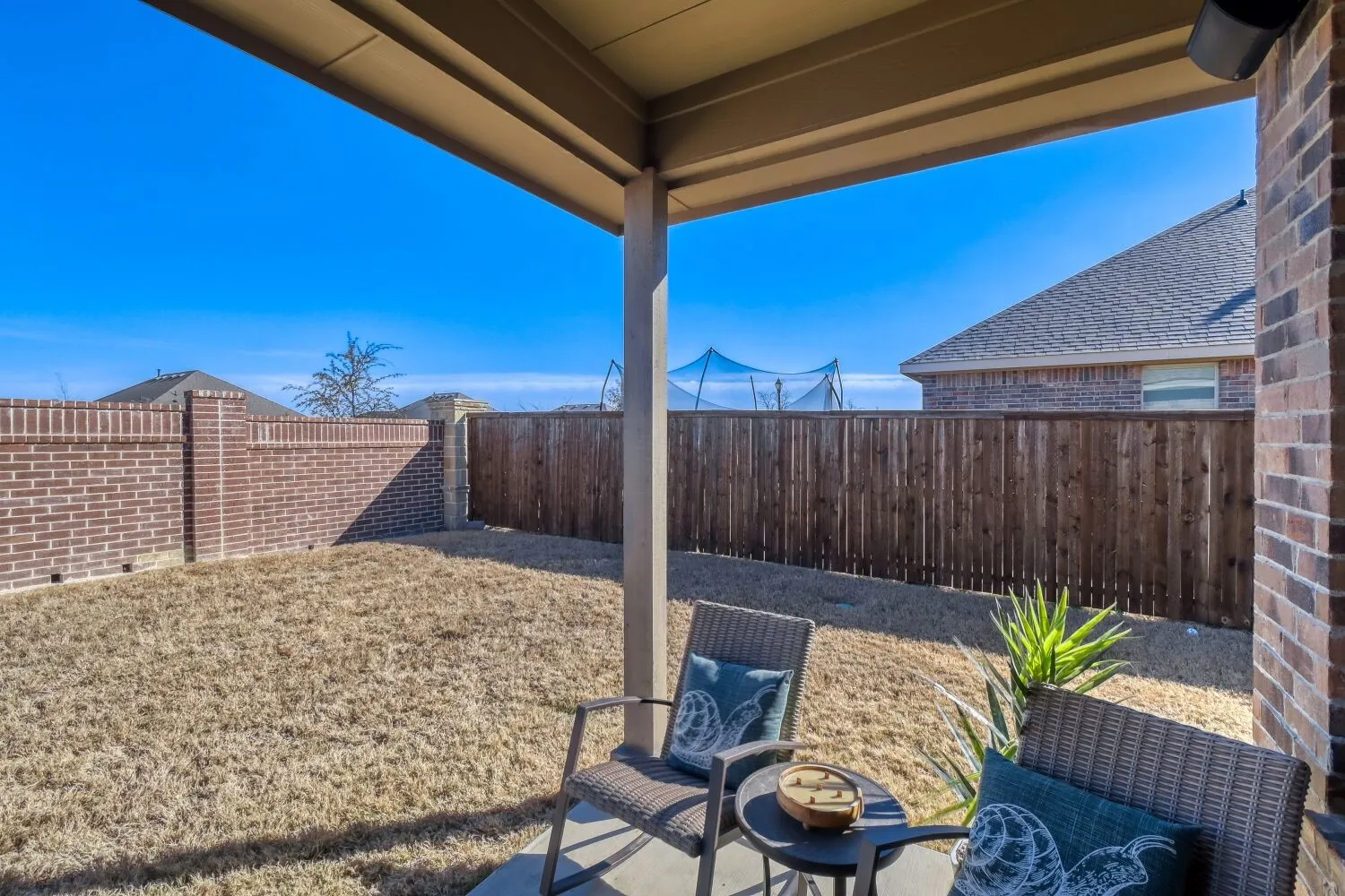 Fenced backyard with a patio
