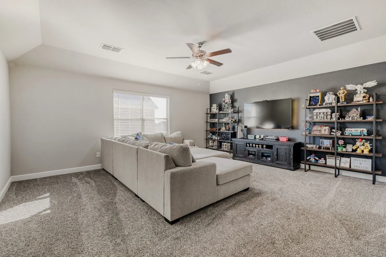 Living room with carpet and ceiling fan