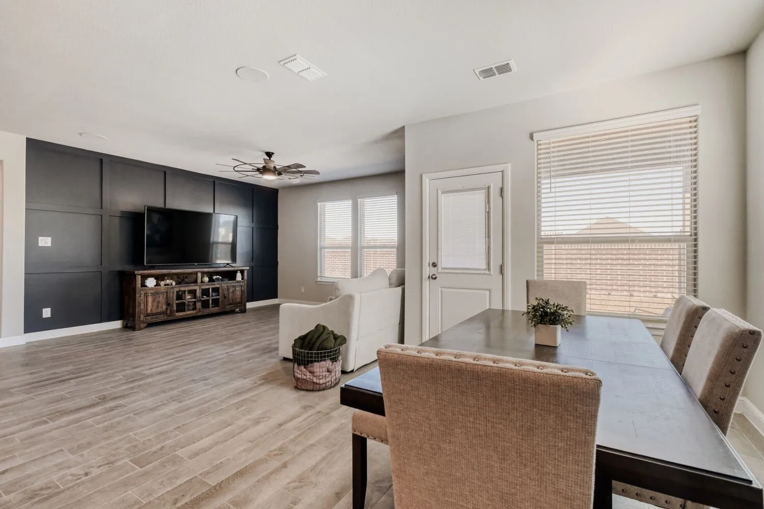 Dining space with light wood-style flooring and ceiling fan