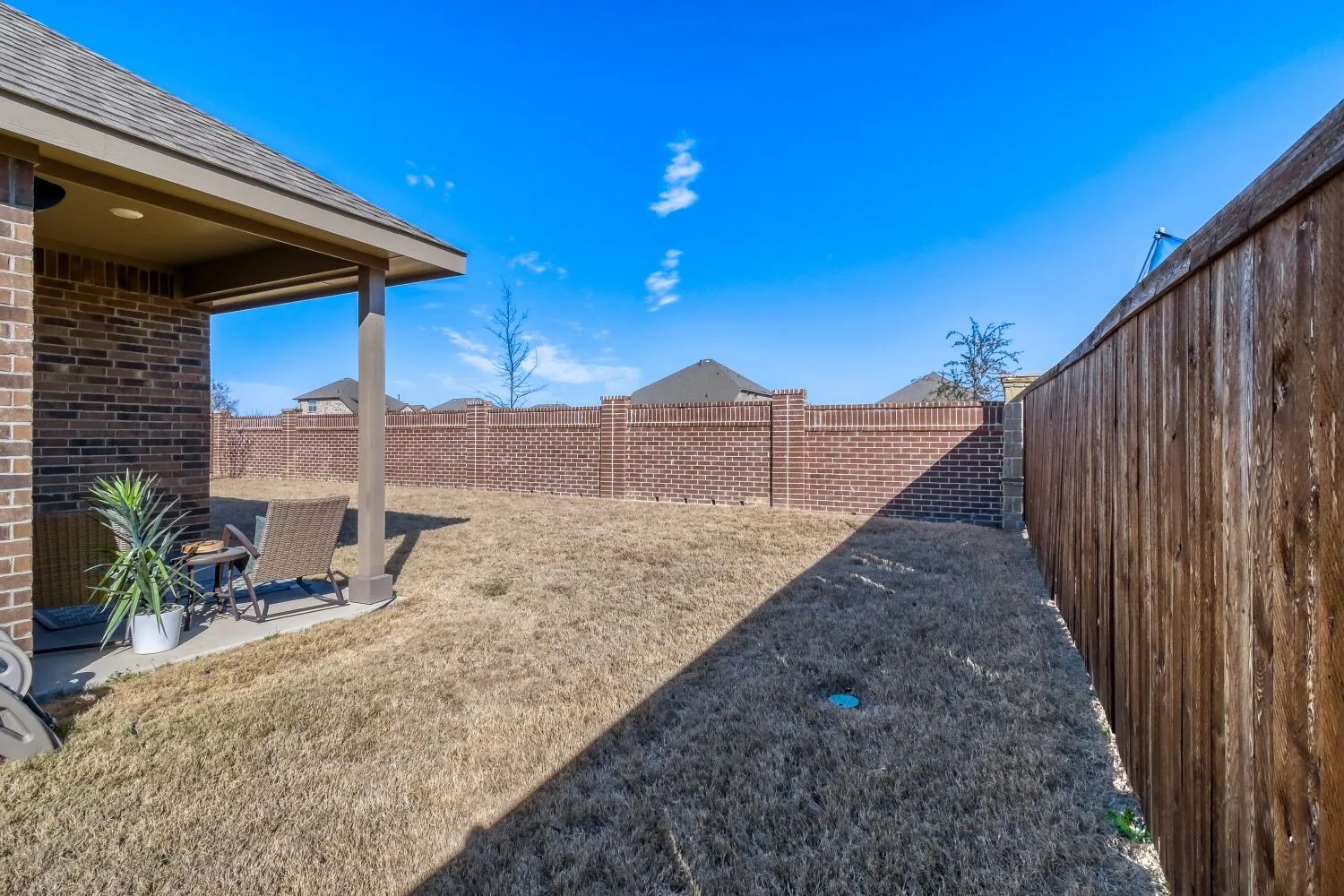 Fenced backyard featuring a patio