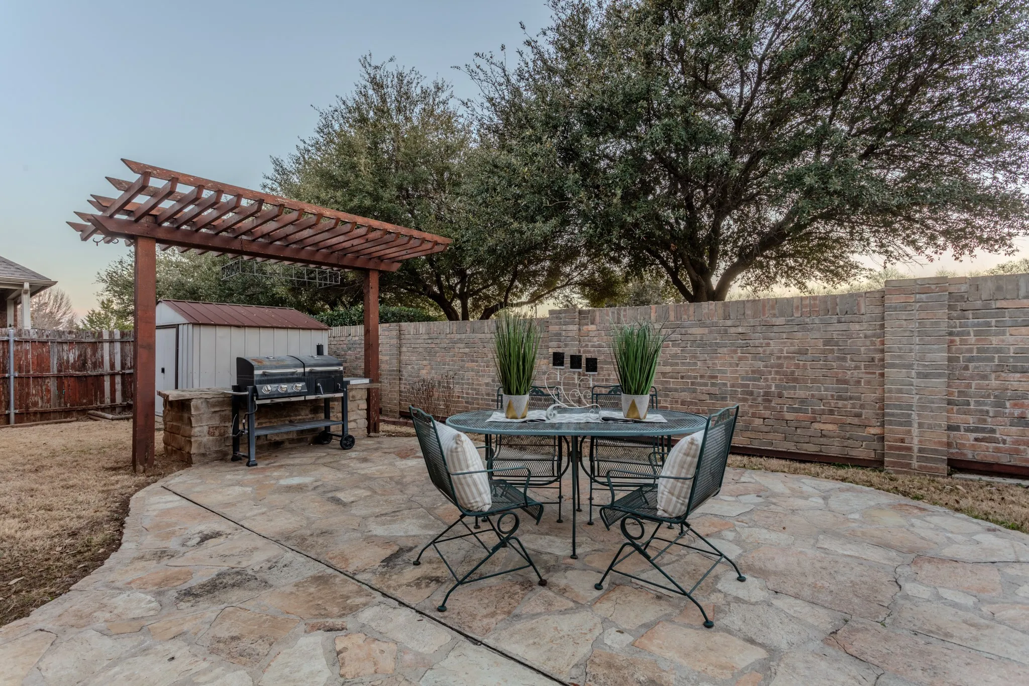 Beautiful flagstone accents enhance the backyard patio, where outdoor dining and relaxing feel like a natural extension of the interior living space.