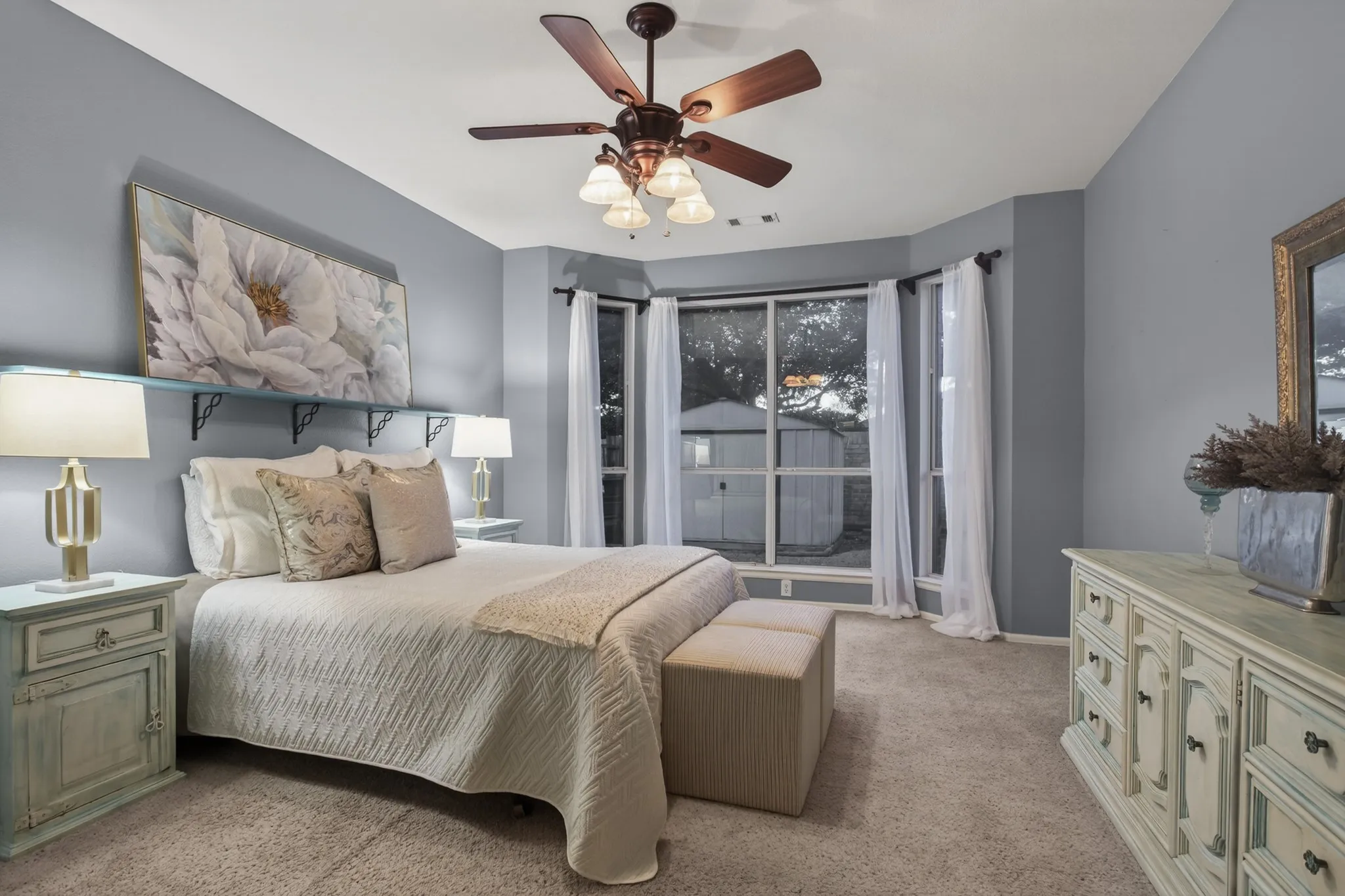 The primary suite personal sanctuary is enhanced by a wall of windows overlooking the backyard.
