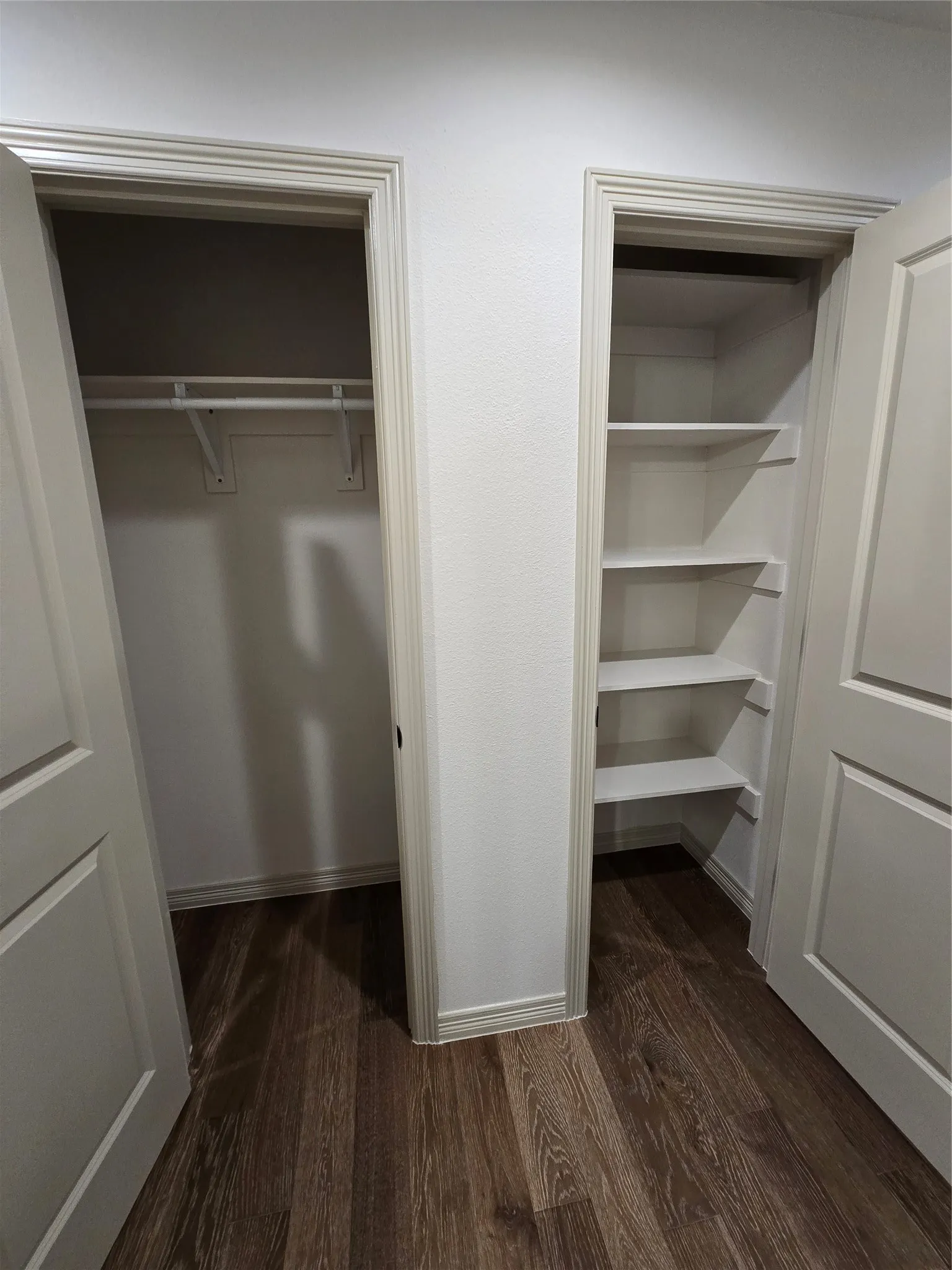 View of hallway with coat and linen closets