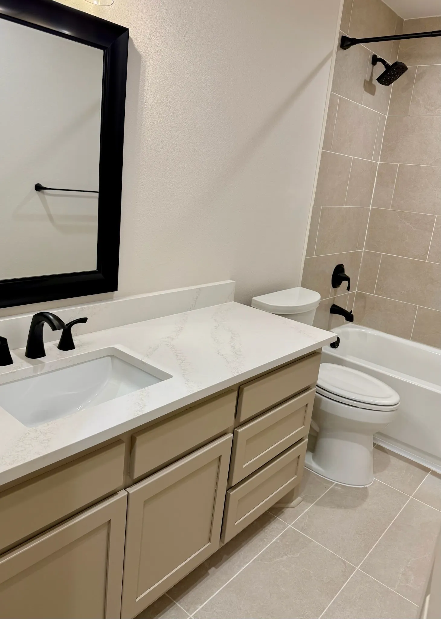 Bathroom with vanity, tile patterned flooring, and bathtub