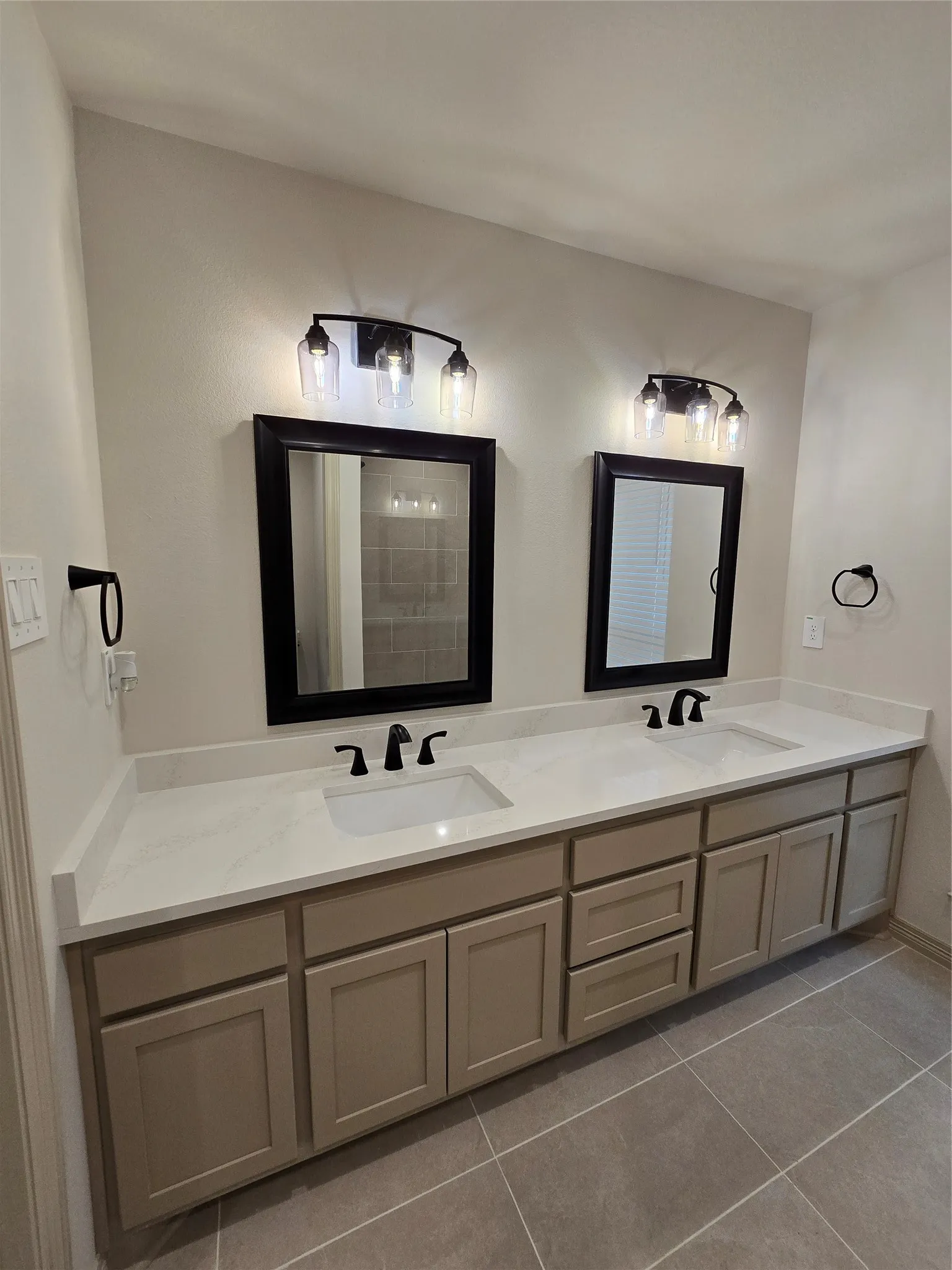 Full bathroom featuring double vanity and tile patterned floors