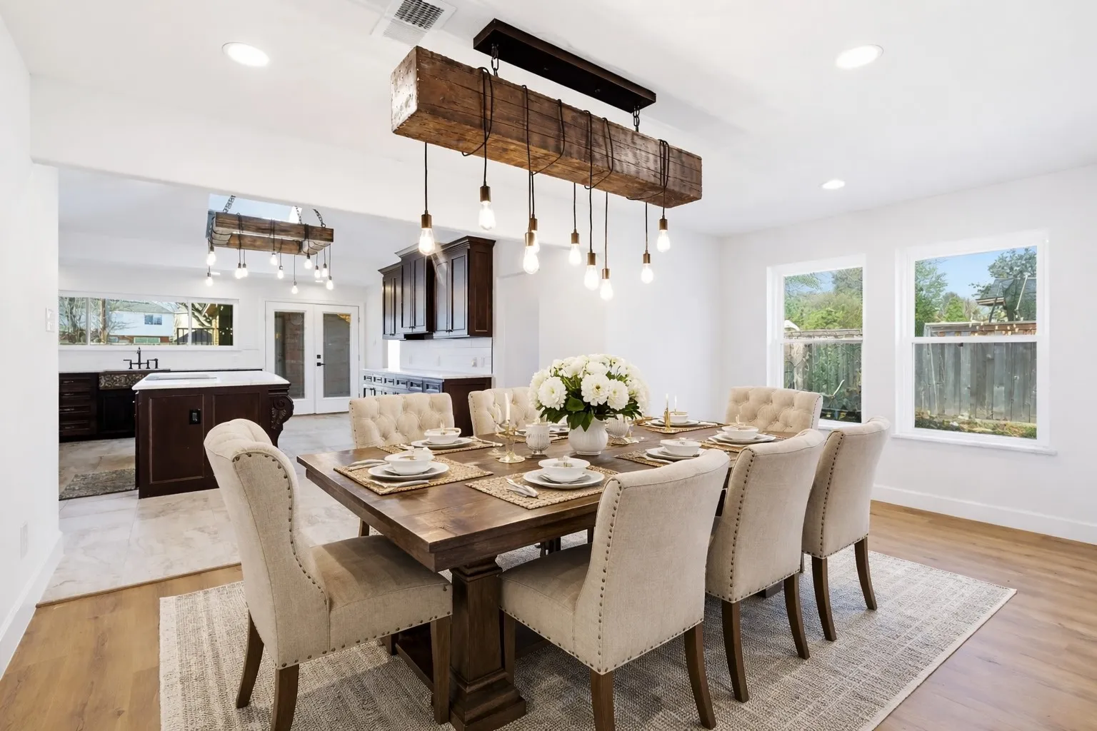 VIRTUALLY STAGED Dining space with french doors, light wood-type flooring, and recessed lighting