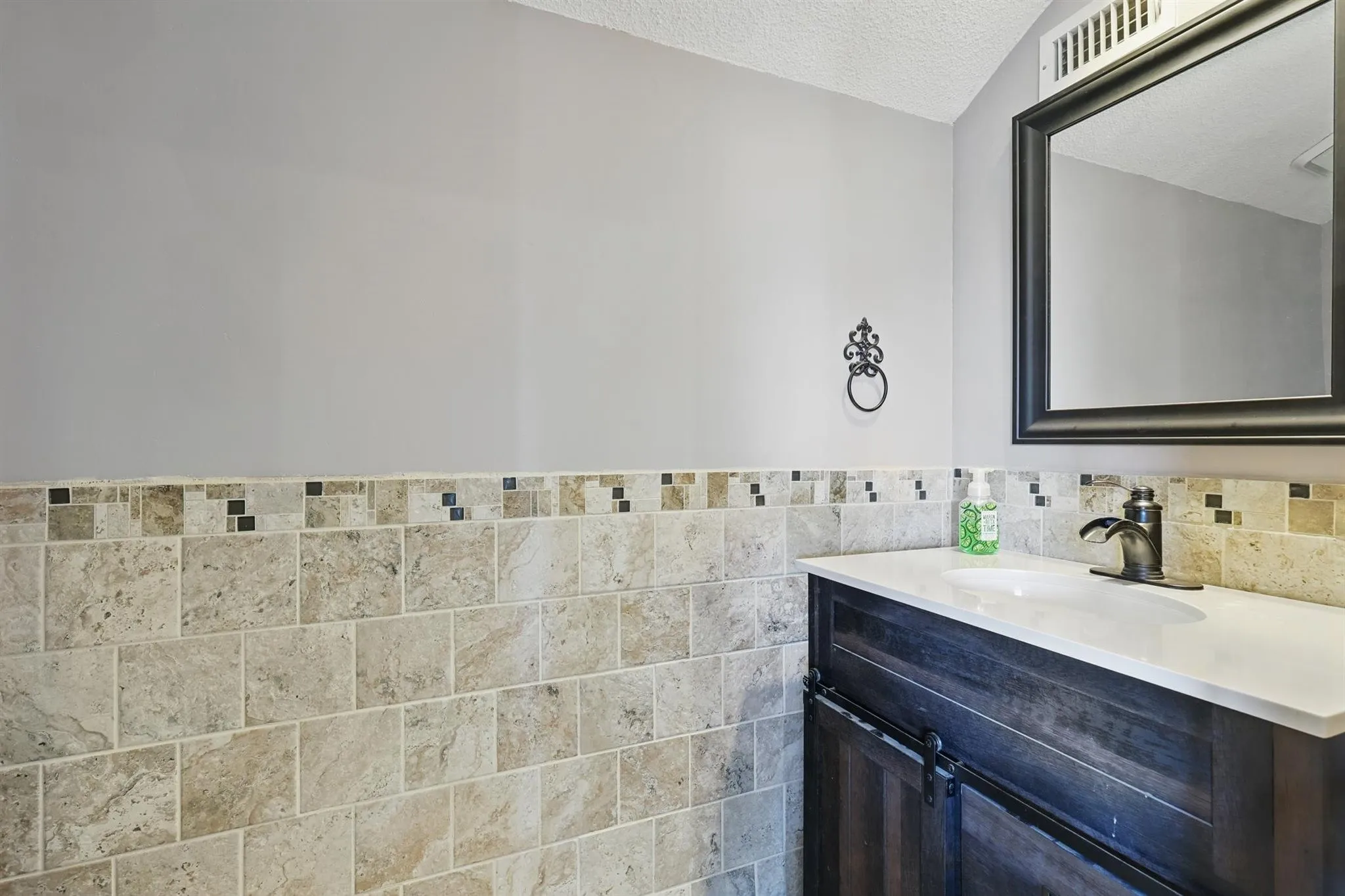 Bathroom featuring vanity and a textured ceiling