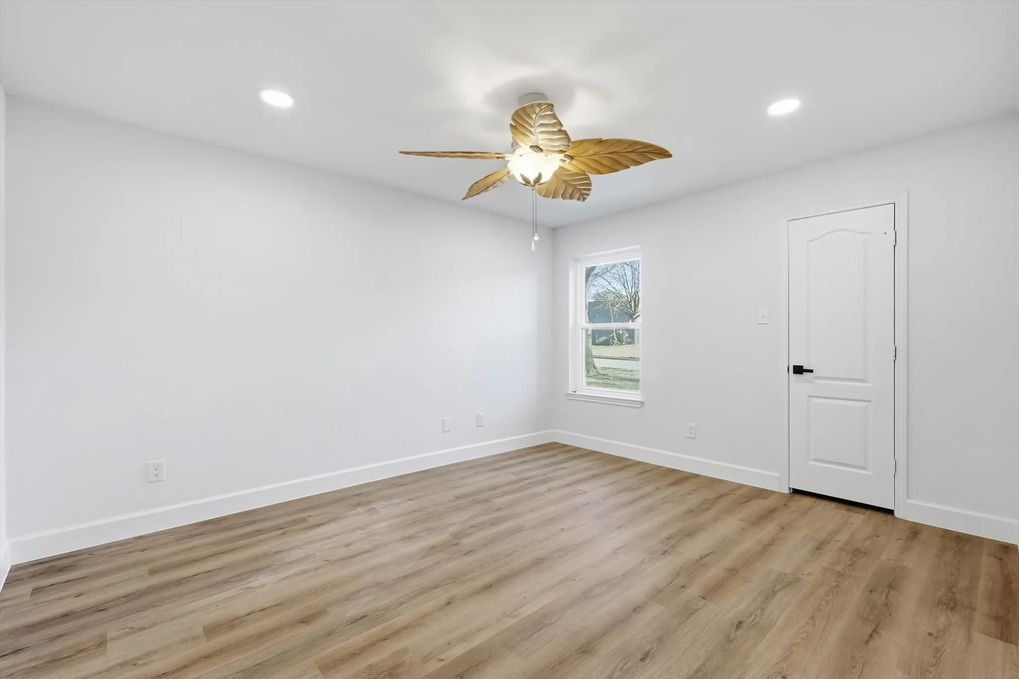 Spare room with a ceiling fan, light wood finished floors, and recessed lighting