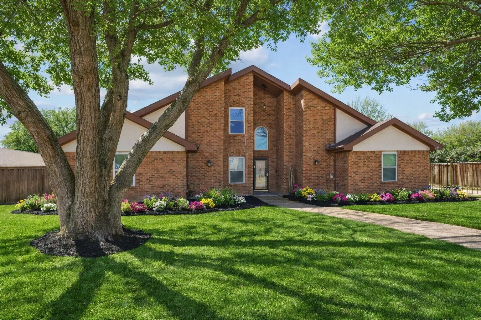 VIRTUAL View of front of home with brick siding and stucco siding