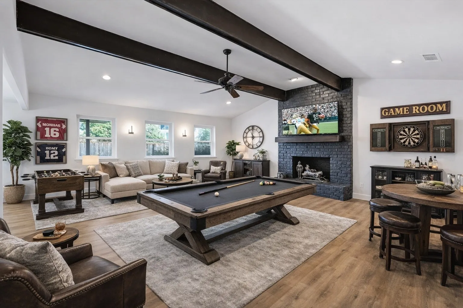 VIRTUALLY STAGED Game room with billiards, wood finished floors, recessed lighting, lofted ceiling with beams, and a brick fireplace