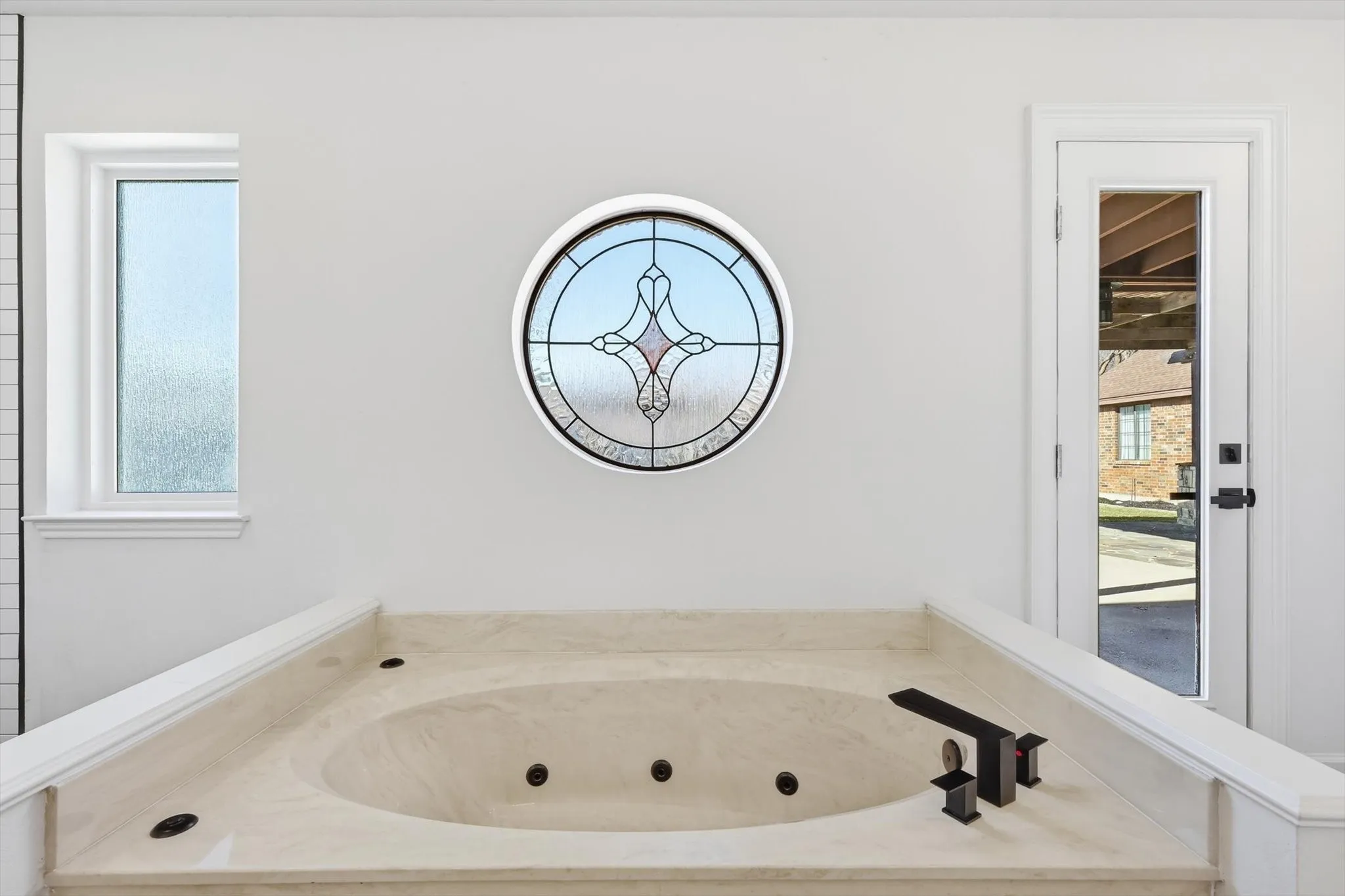 Full bath with a tub with jets