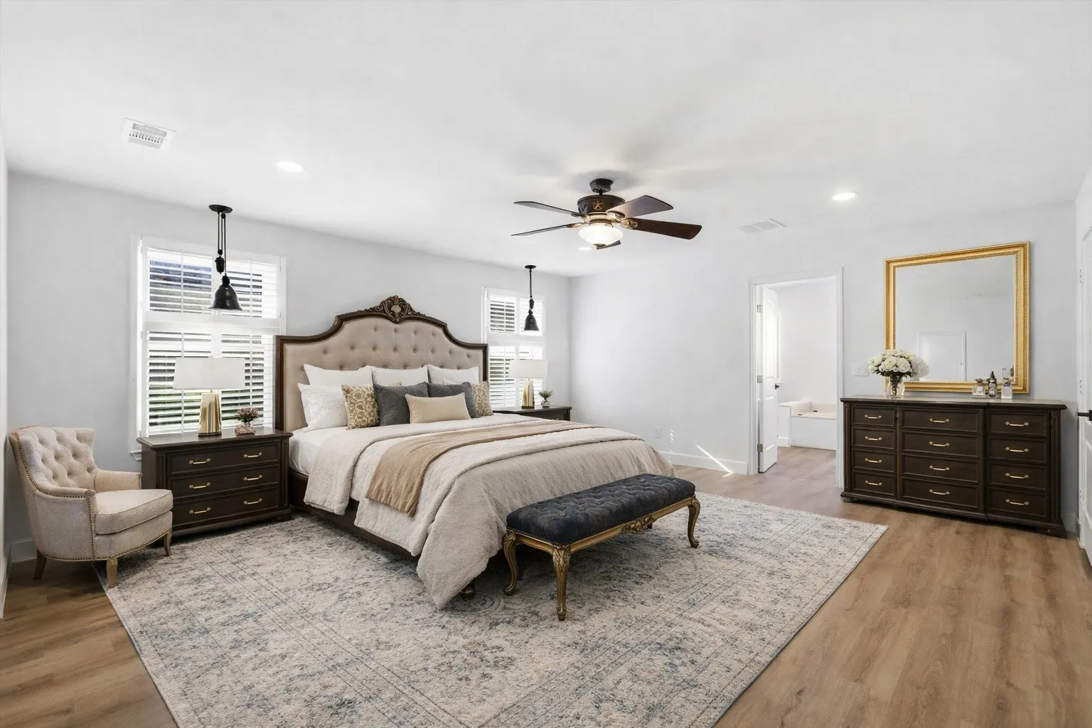 VIRTUALLY STAGED Bedroom featuring light wood-style flooring, a ceiling fan, recessed lighting, and connected bathroom