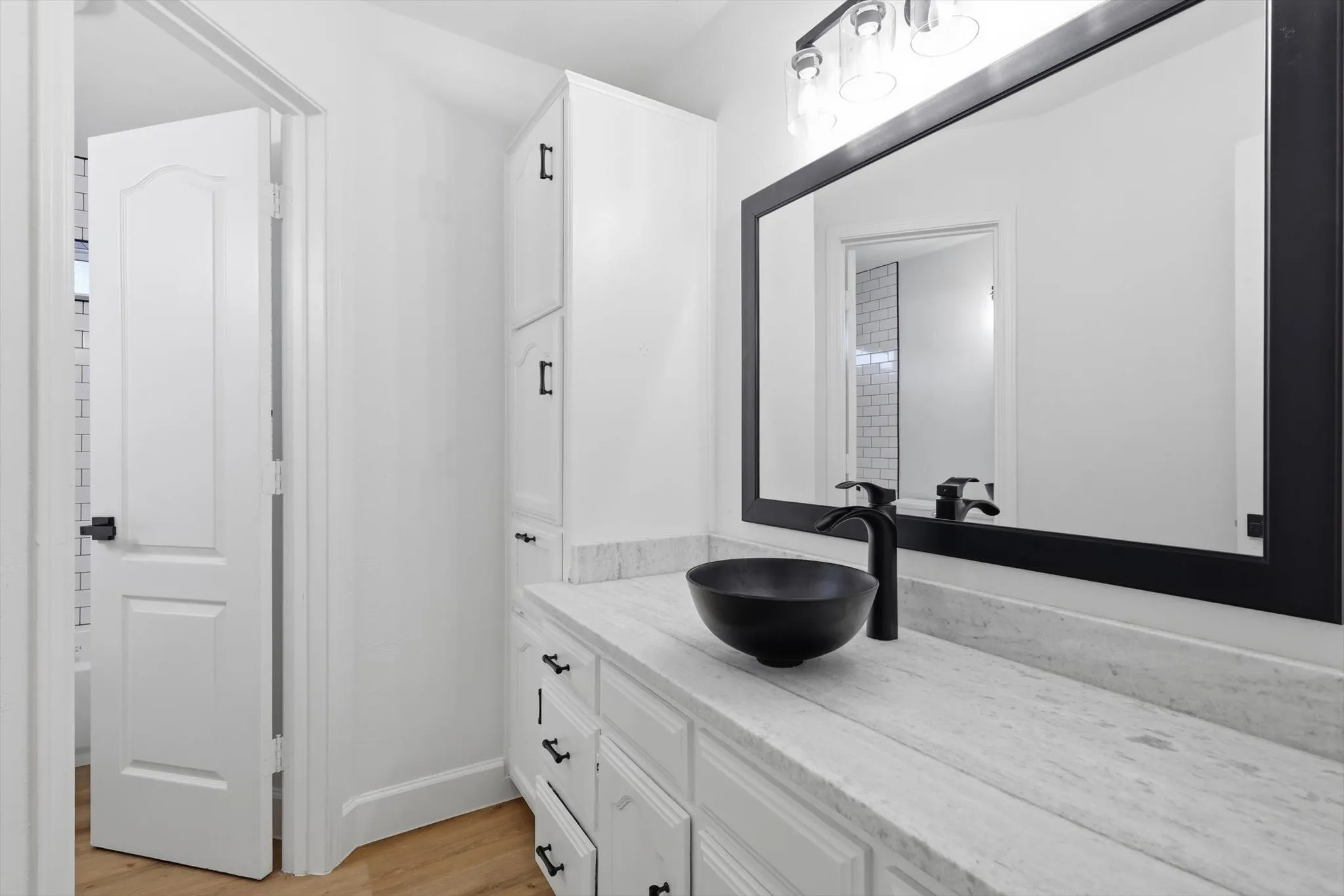 Bathroom featuring vanity and light wood-style floors