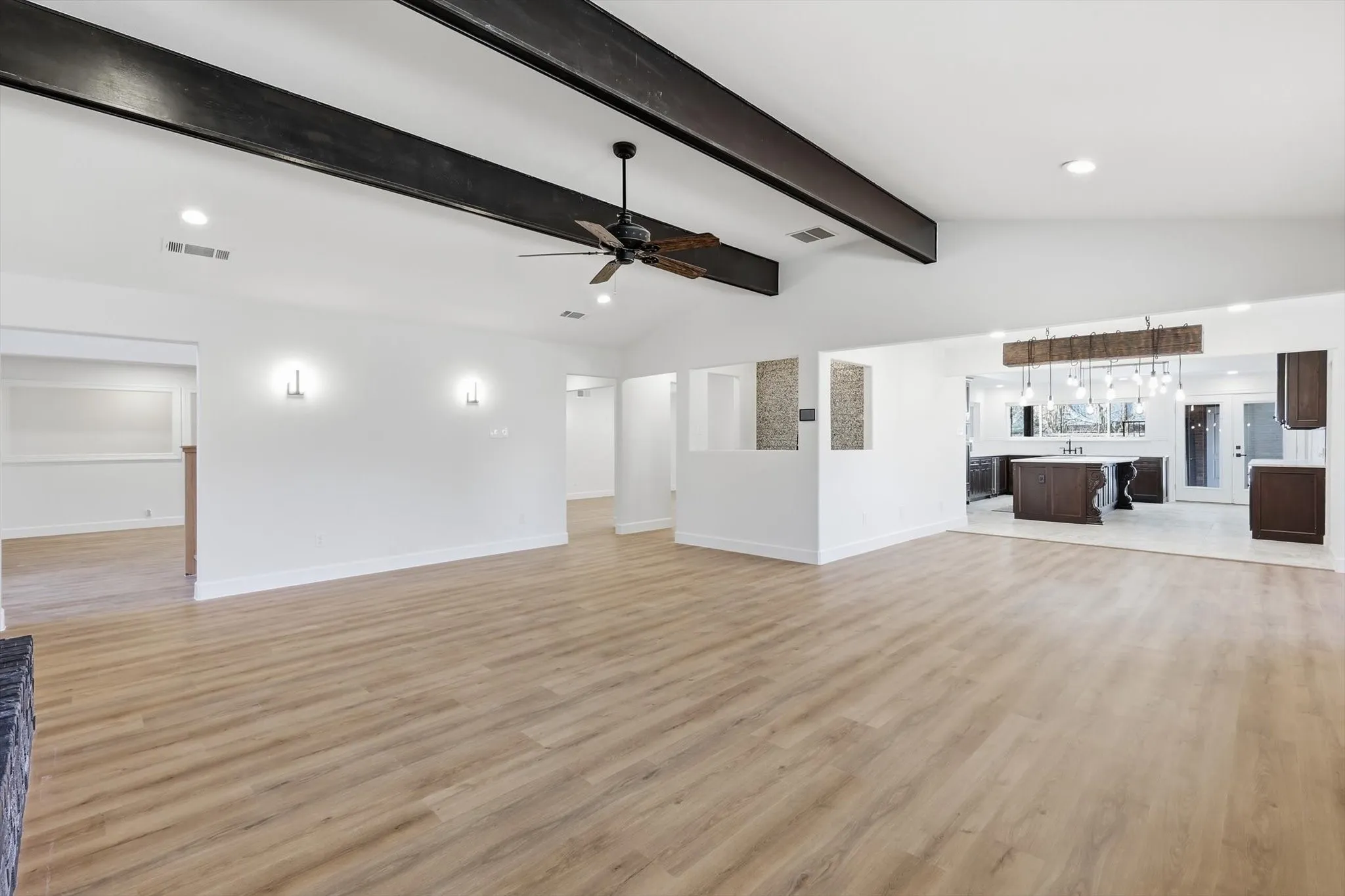 Unfurnished living room with recessed lighting, vaulted ceiling with beams, light wood-type flooring, and a ceiling fan