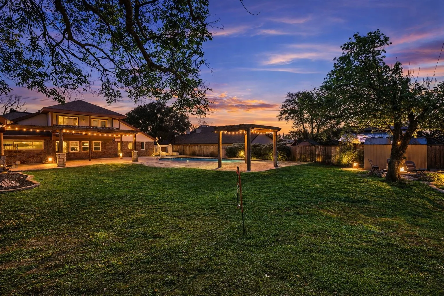 Fenced backyard featuring a pergola and a patio