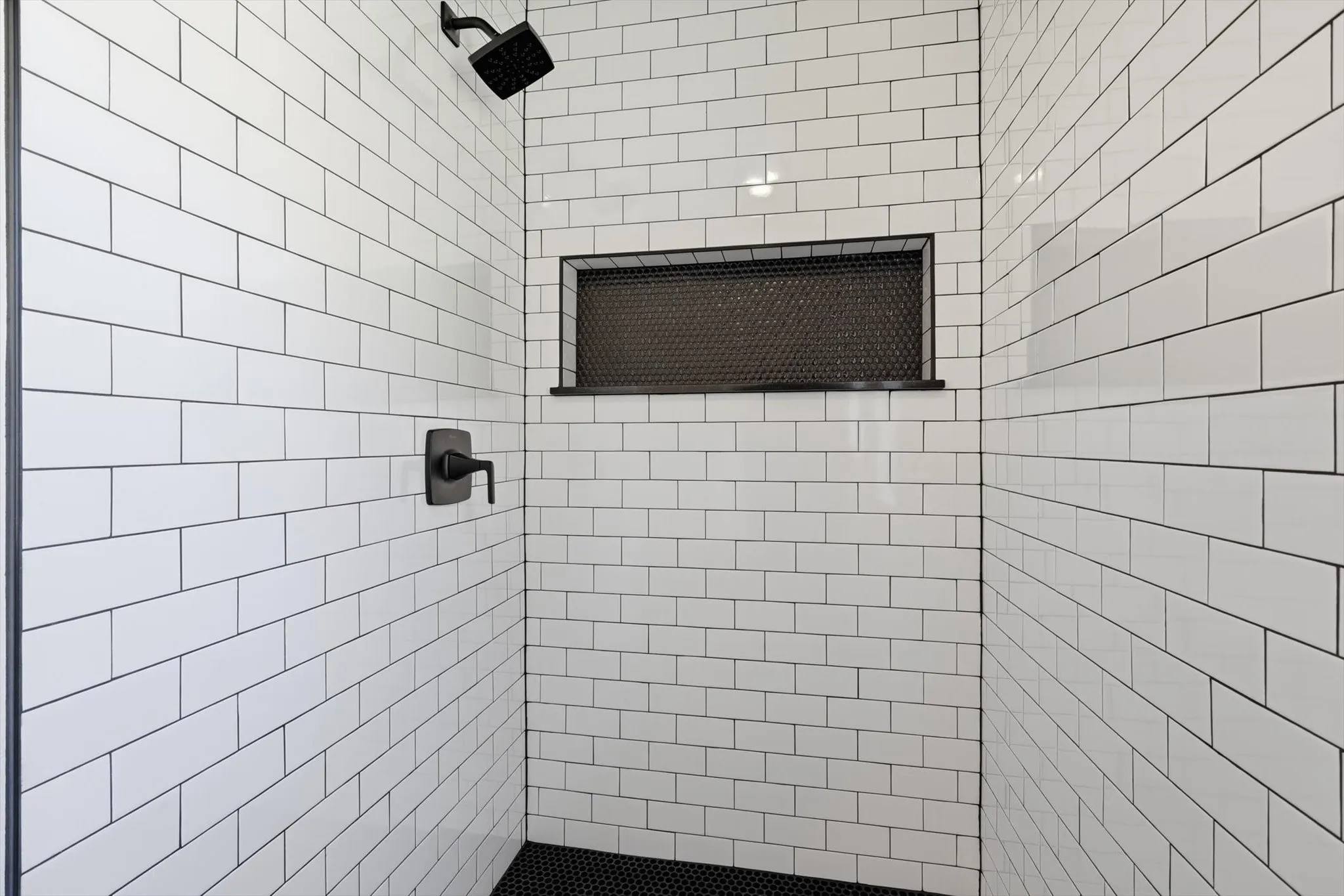 Full bath featuring tiled shower