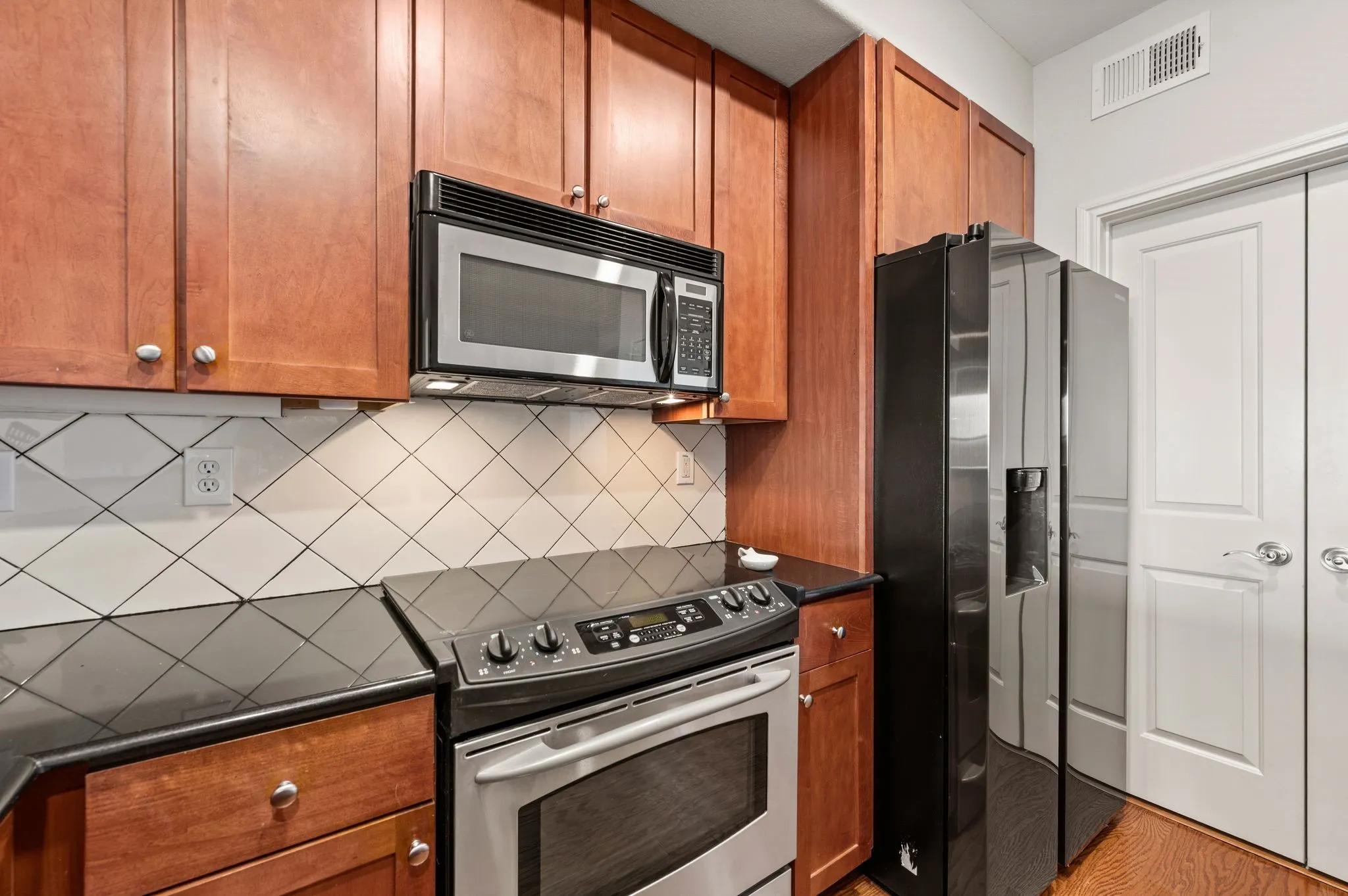 Kitchen with stainless steel appliances and wood finish cabinets