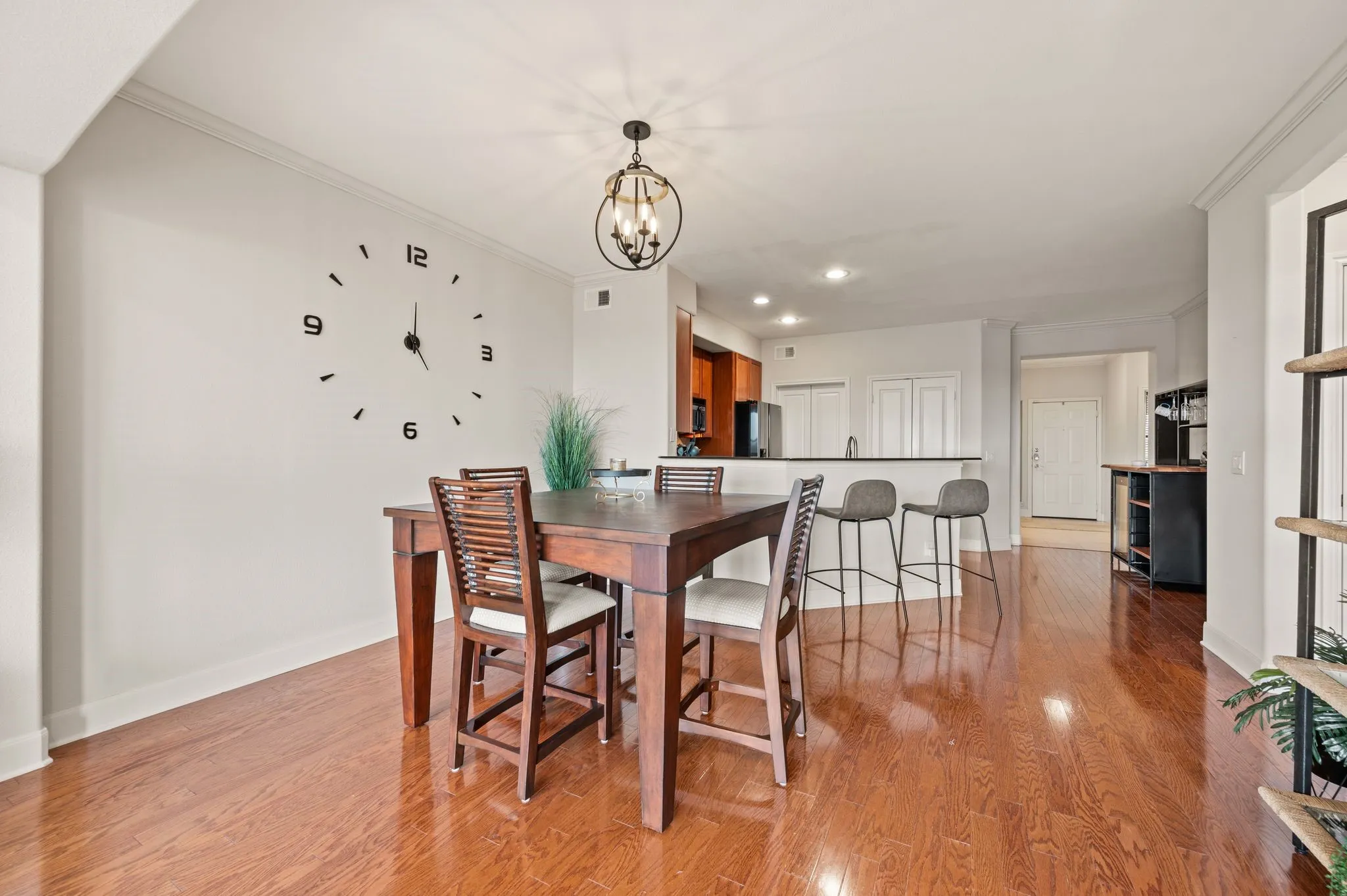 Dining area featuring crown molding, light wood finished floors, and a chandelier