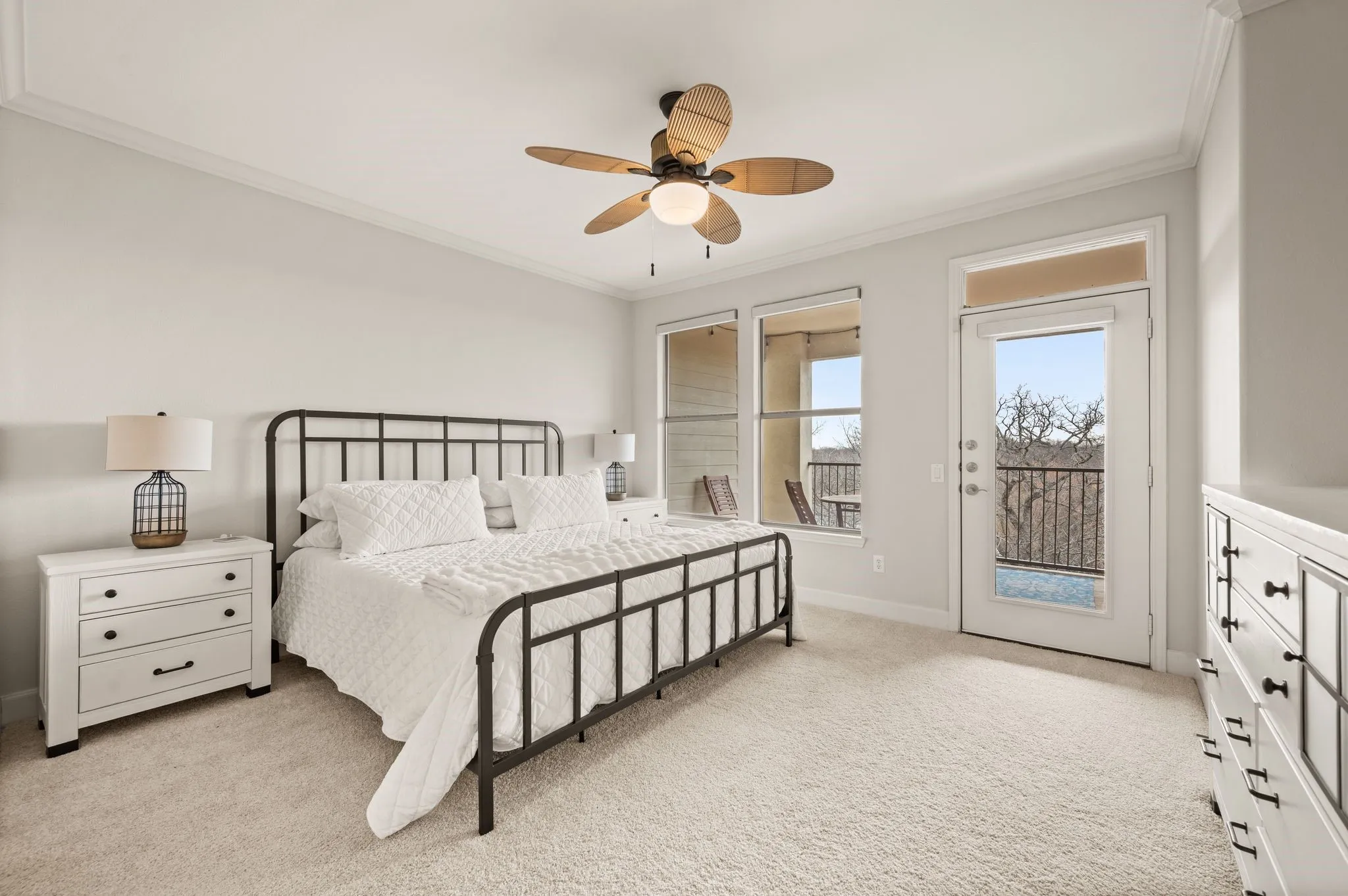 Primary Bedroom featuring access to exterior, crown molding, light colored carpet, and a ceiling fan